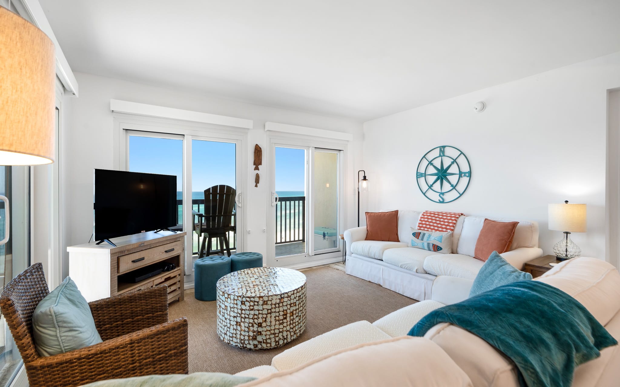 Relax in this bright coastal living room with gulf views, cozy seating, and nautical touches that make you feel right at home.