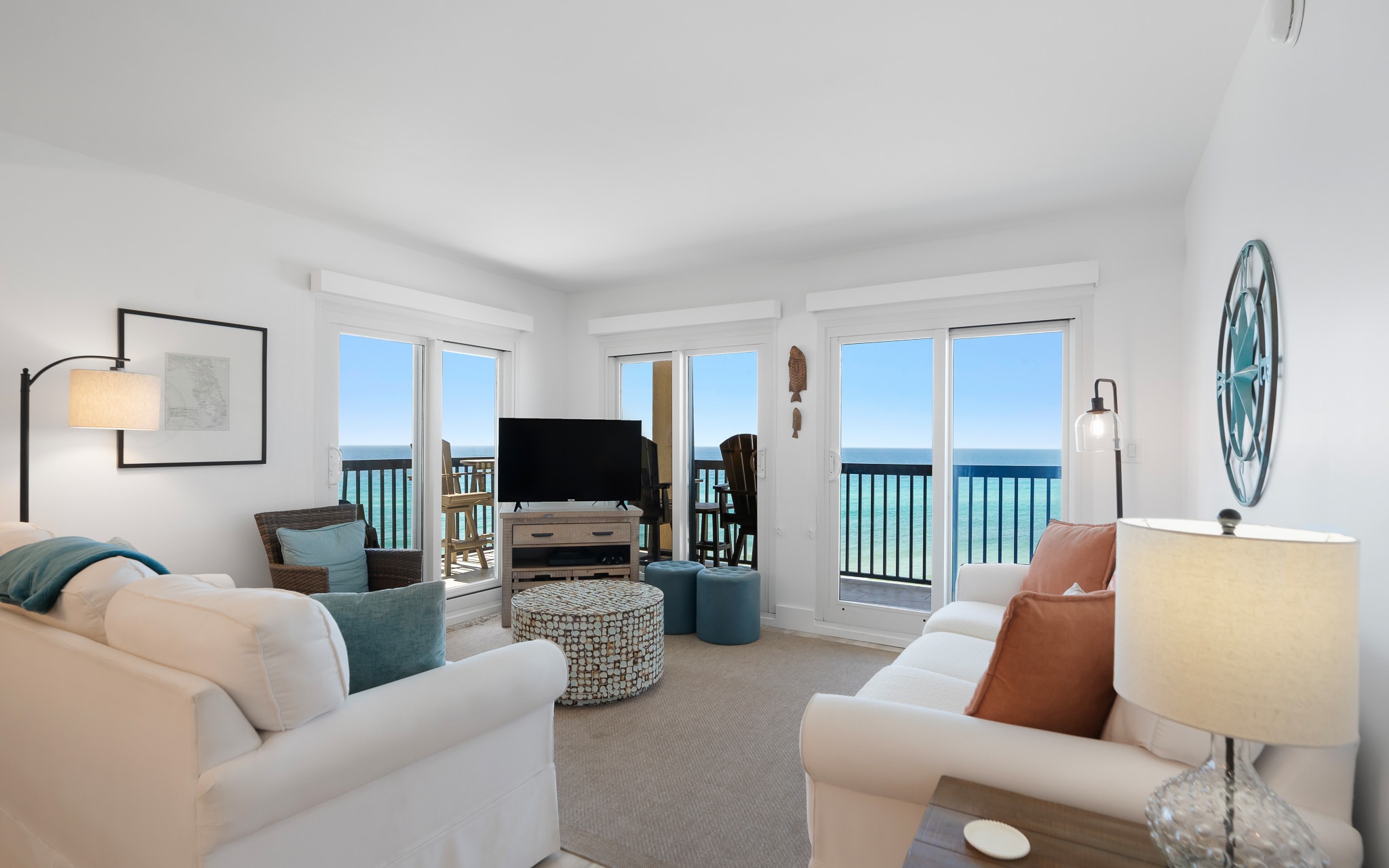 Unwind in your bright oceanfront living room where panoramic sea views stretch beyond French doors to your private balcony.