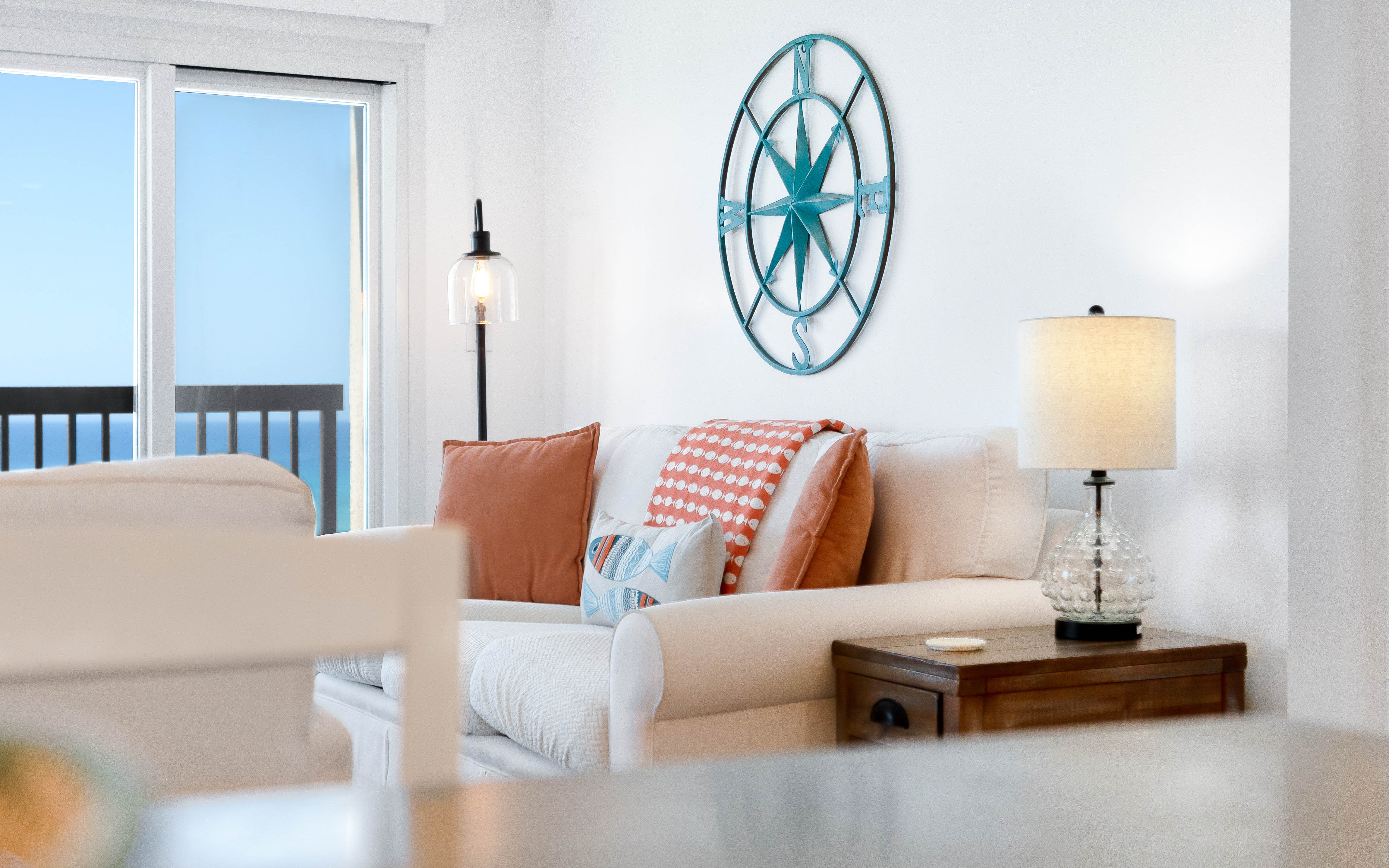Sink into this coastal living room where gulf views meet comfort. Nautical touches and warm pillows create your perfect seaside retreat.