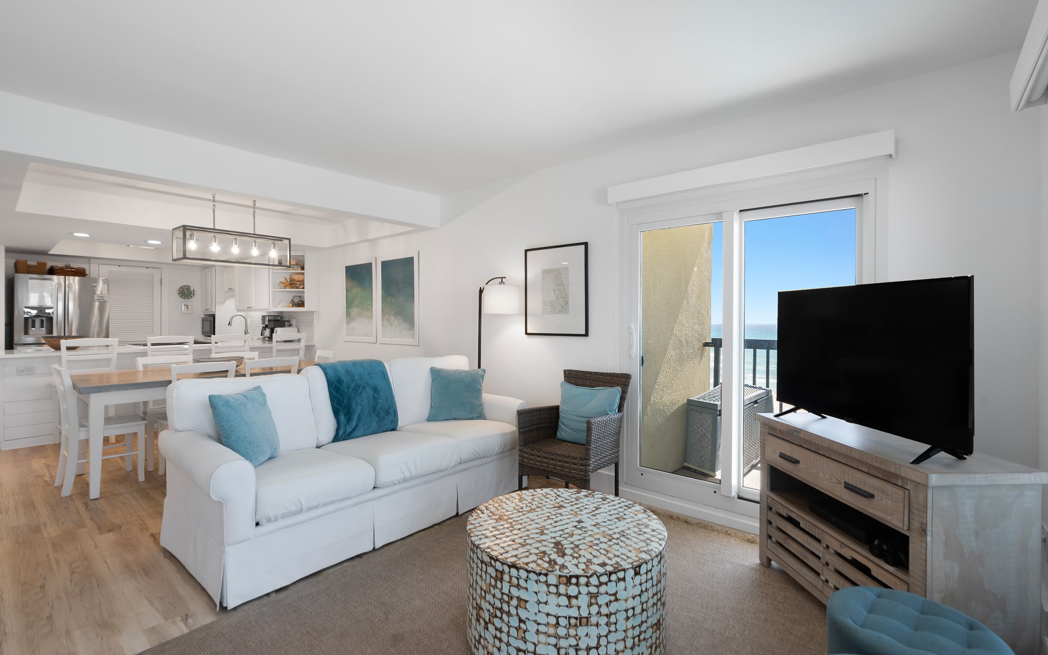 Your bright, coastal living room blends comfort with modern style, featuring gulf-inspired blues and a private balcony for morning coffee moments.