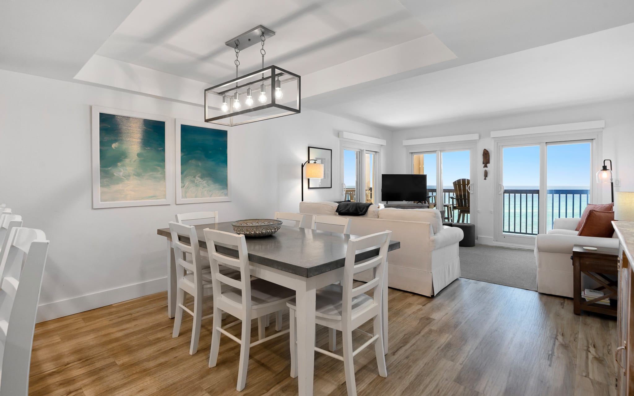 Relax in your bright oceanfront living space where coastal artwork and open-plan design create the perfect seaside retreat.
