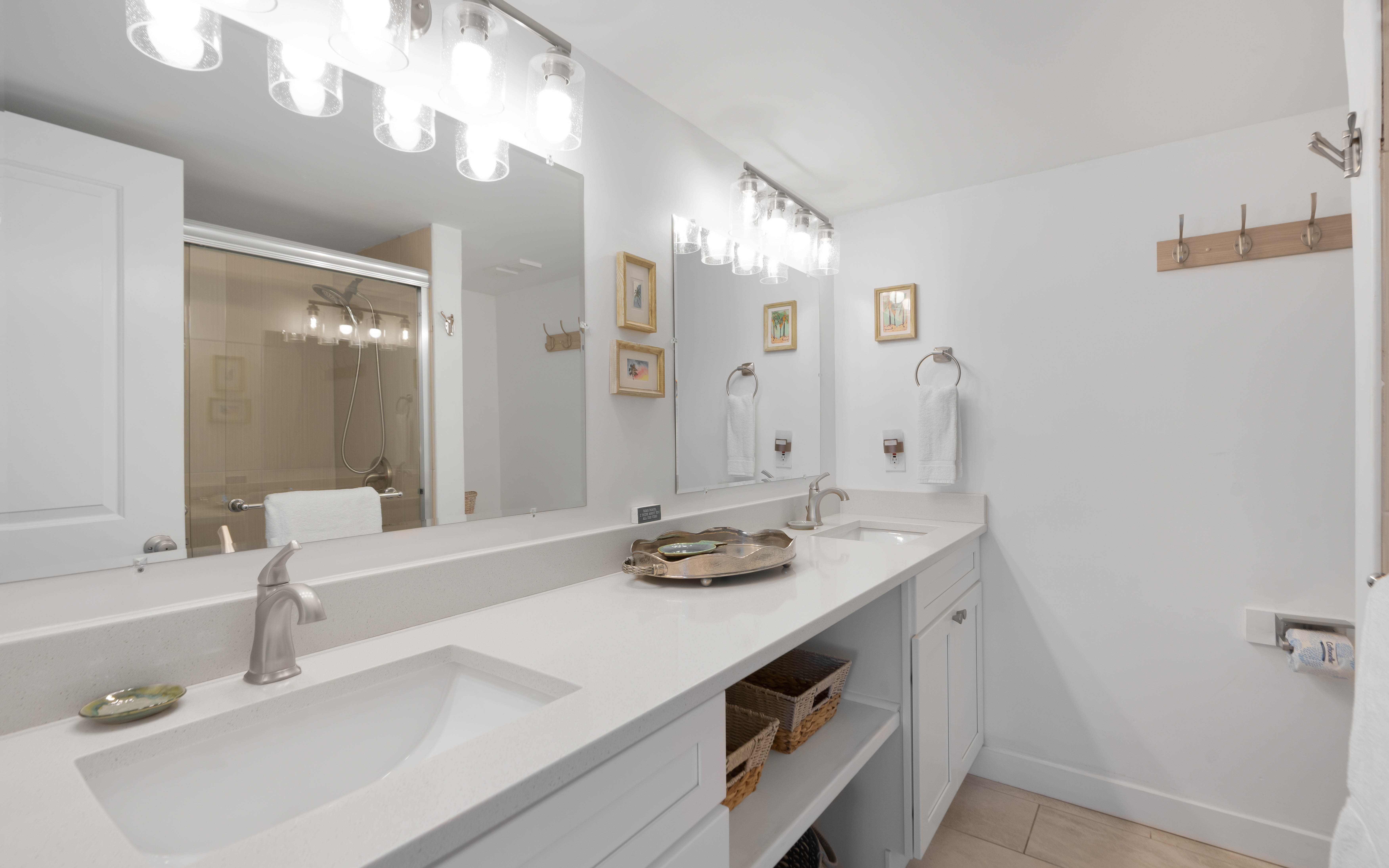 Your spacious bathroom features dual vanities with elegant white countertops, perfect for getting ready together each morning.