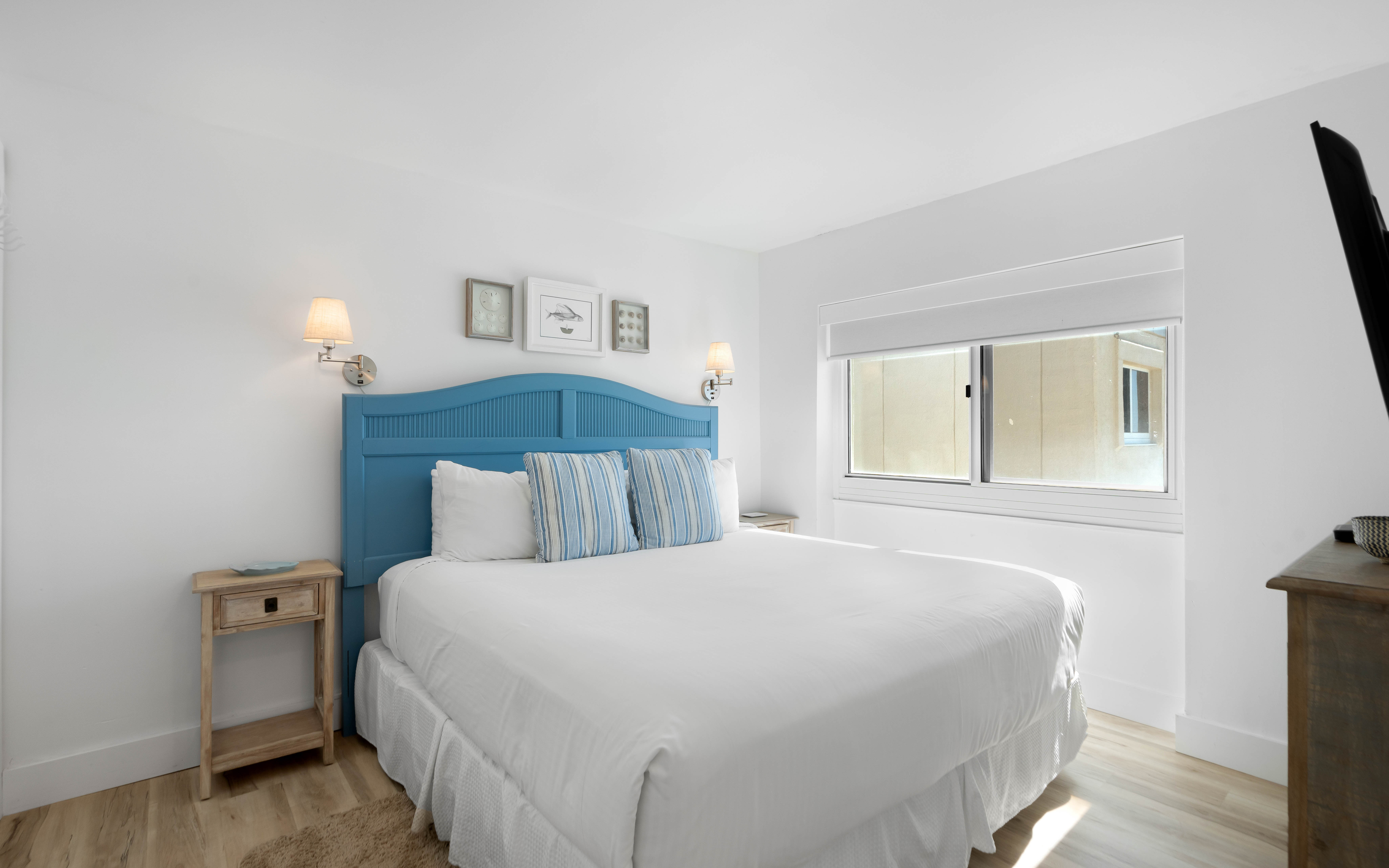 Sink into crisp white linens and let the coastal blue headboard transport you to seaside dreams in your peaceful retreat.