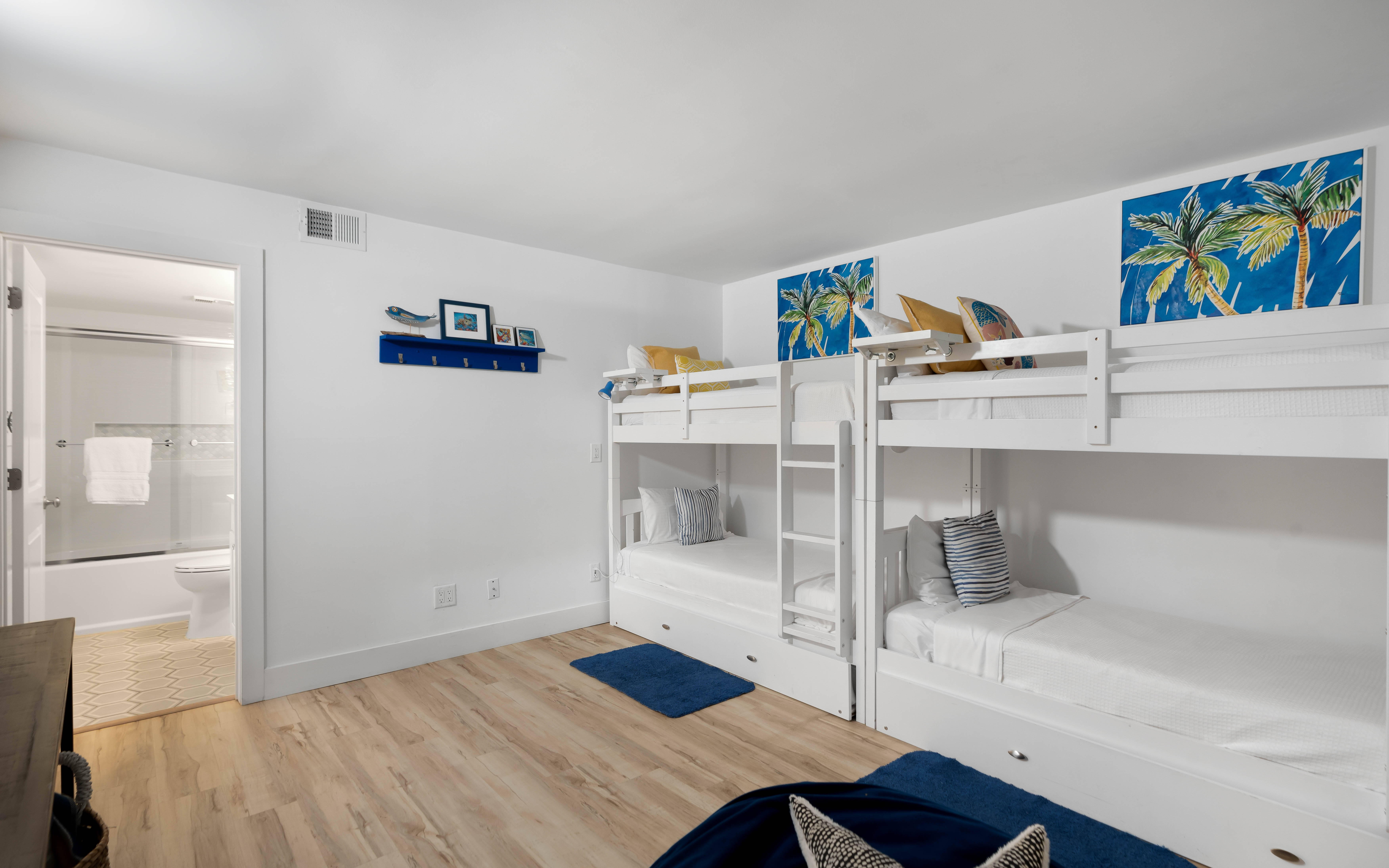 Your group will love this cheerful bunk room with tropical artwork and cozy bedding for four.