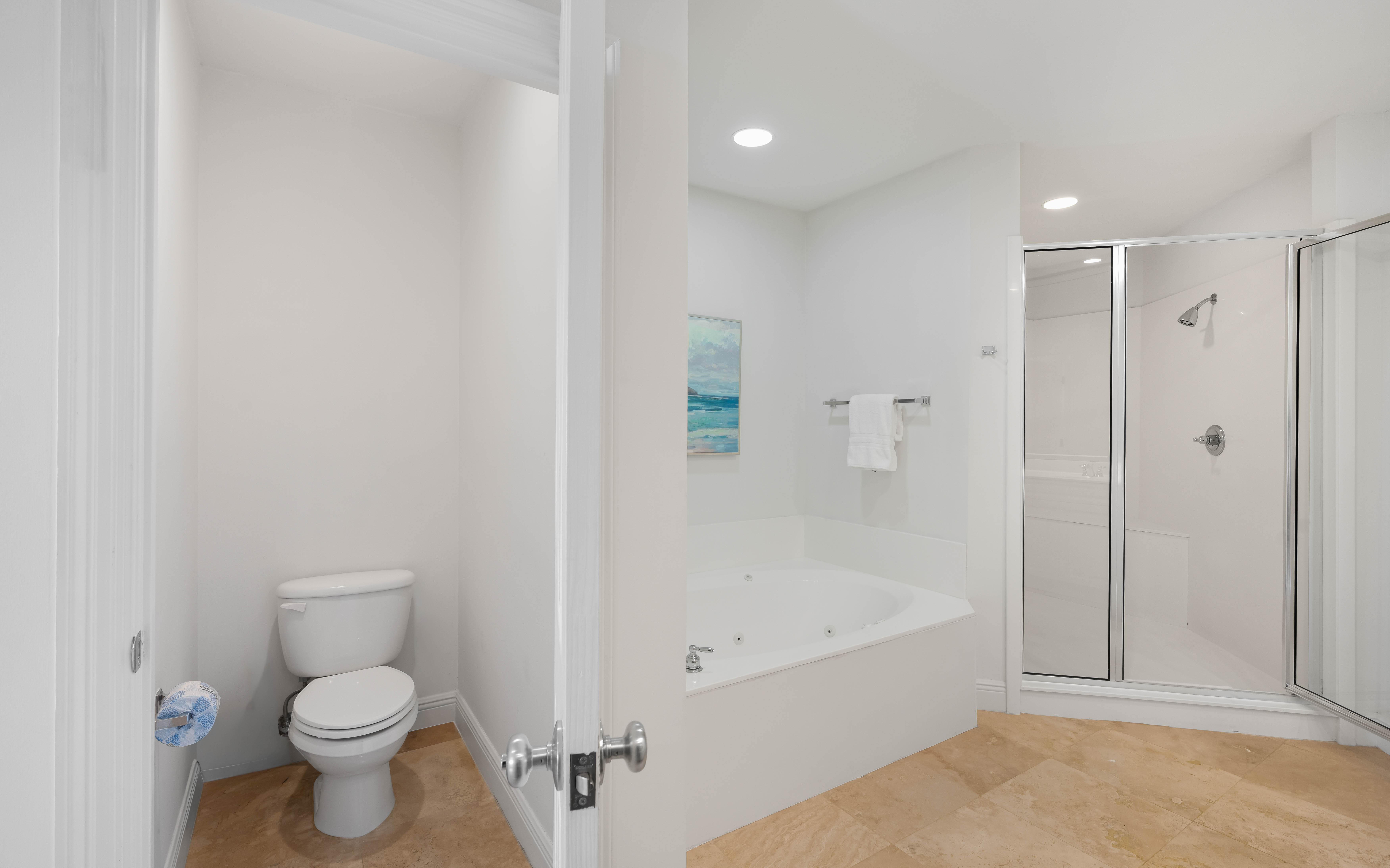 Unwind in your spacious bathroom with a luxurious soaking tub and separate glass shower for ultimate relaxation.