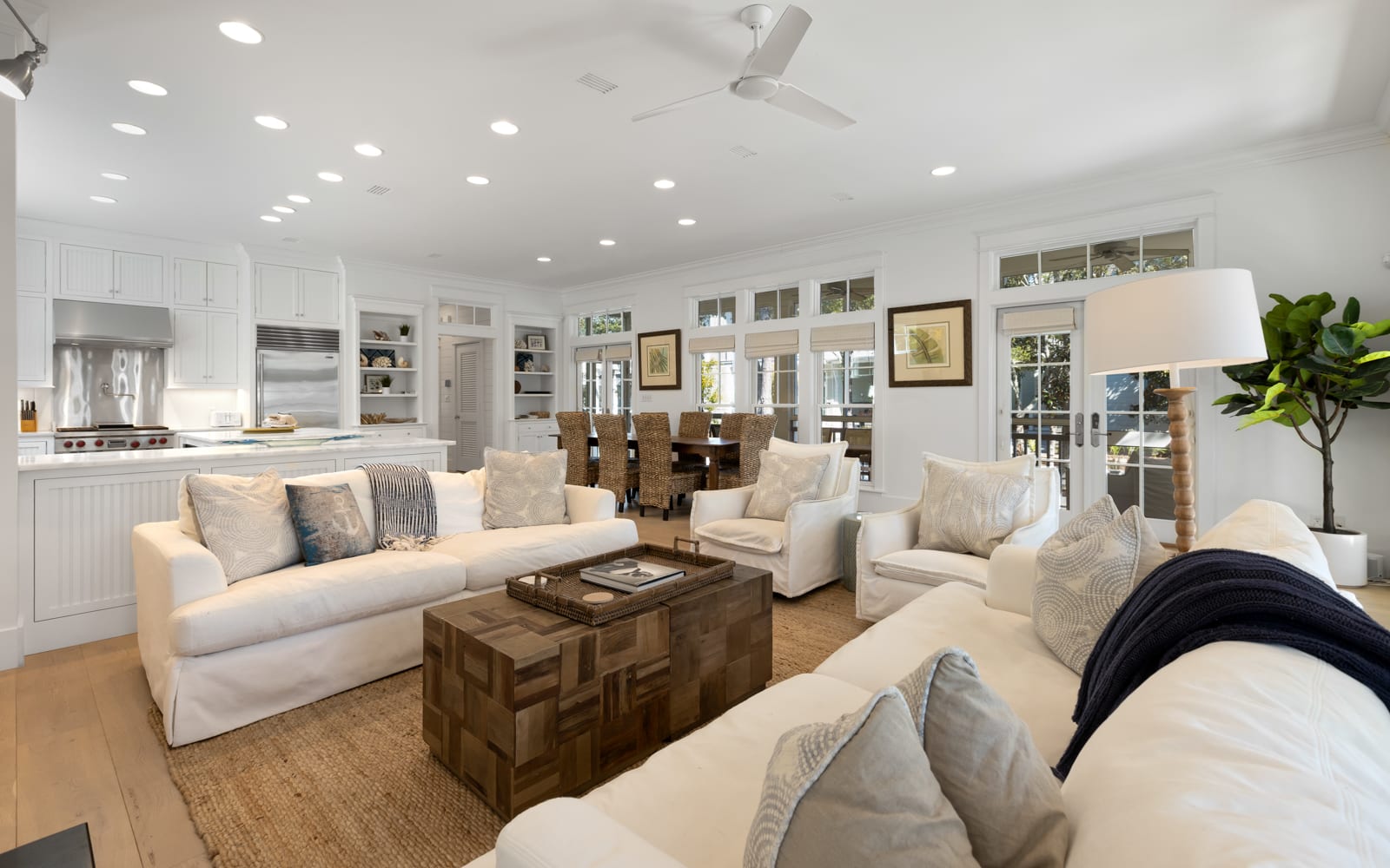 Sink into plush white sofas in your open-concept haven, where kitchen and living flow seamlessly together for perfect entertaining.