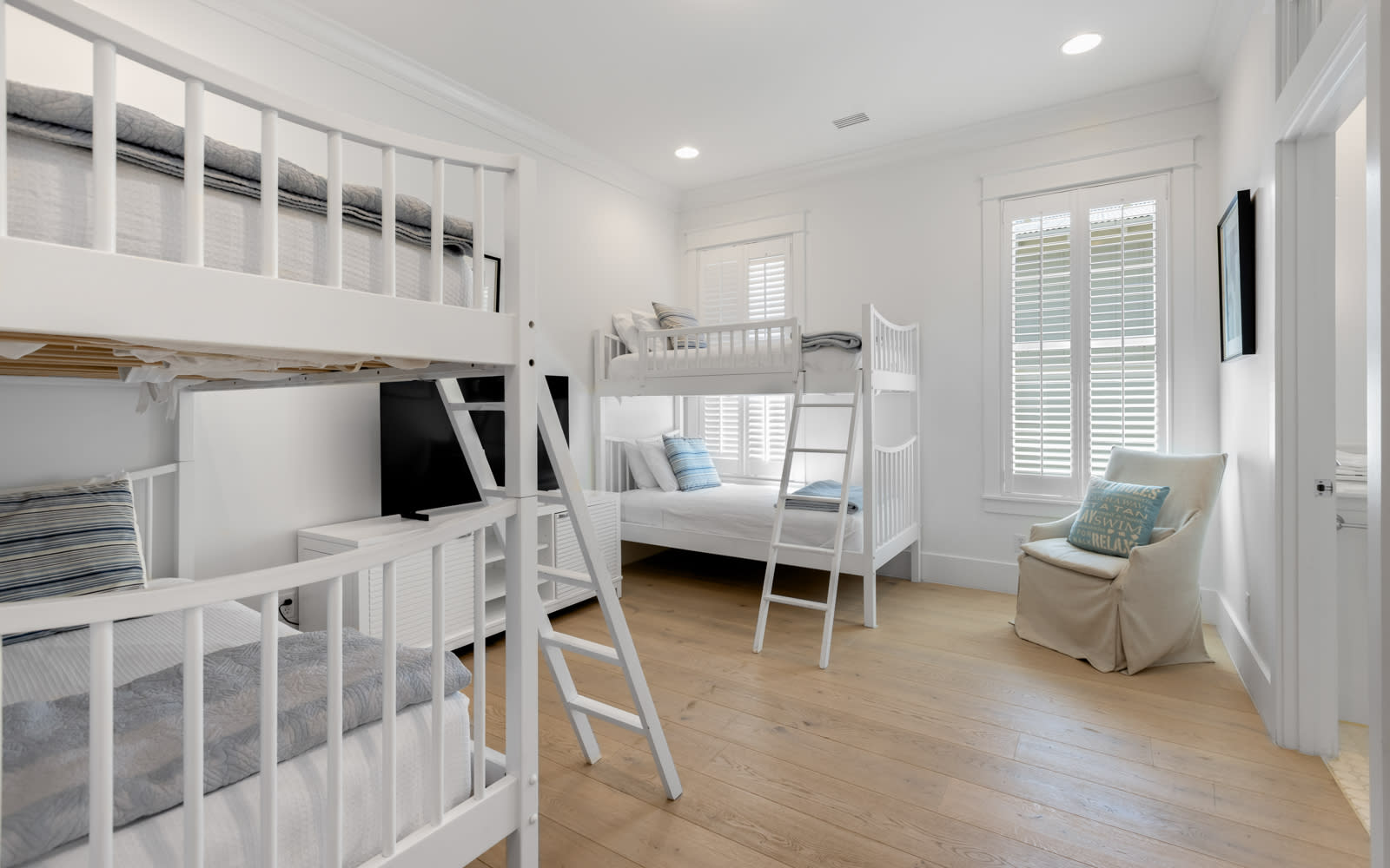 Sleep soundly in this bright bunk room featuring comfortable beds and cozy seating for your family's perfect rest.