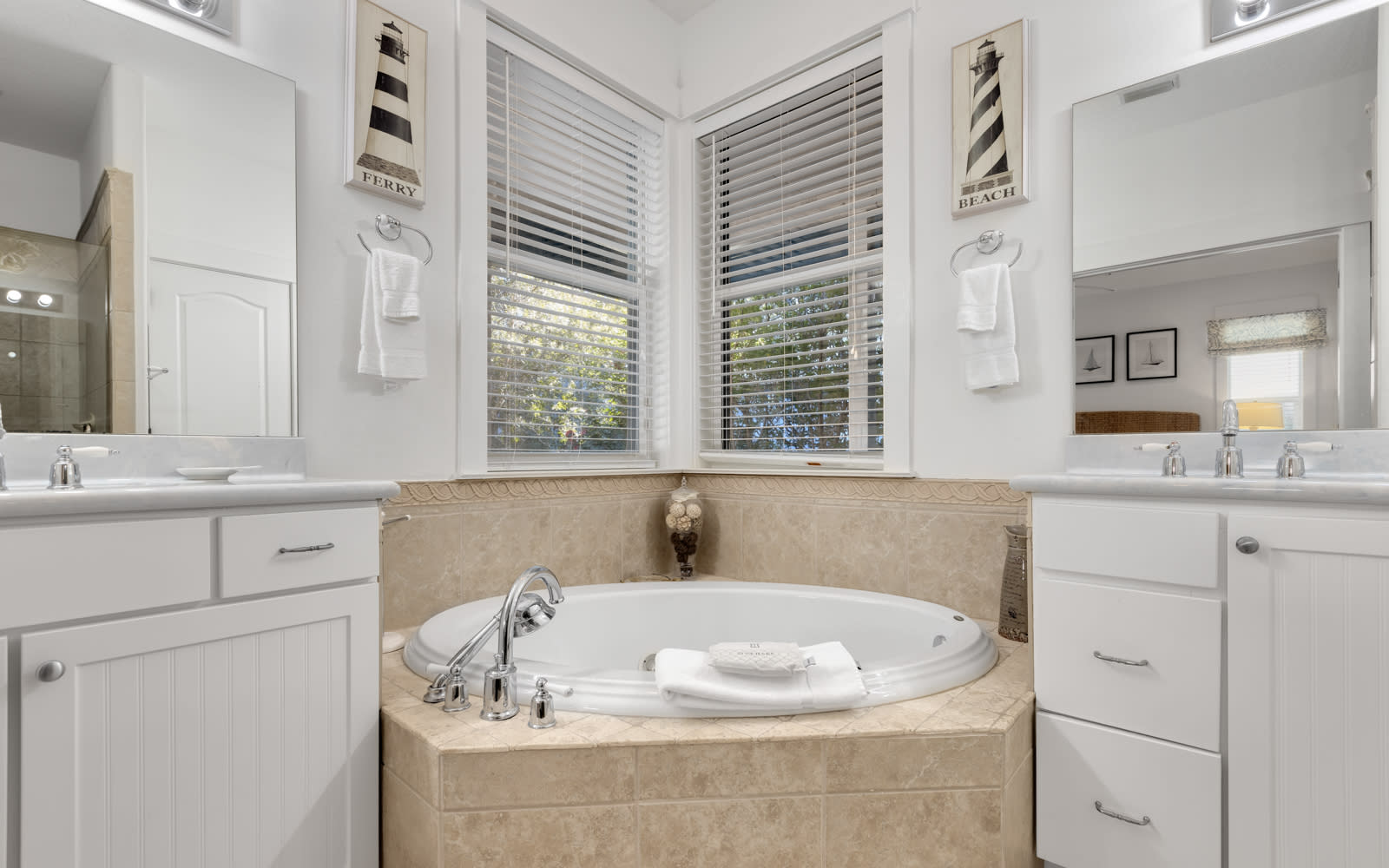 Luxurious master bath with soaking tub where you can unwind after your day, bathed in natural light from windows.