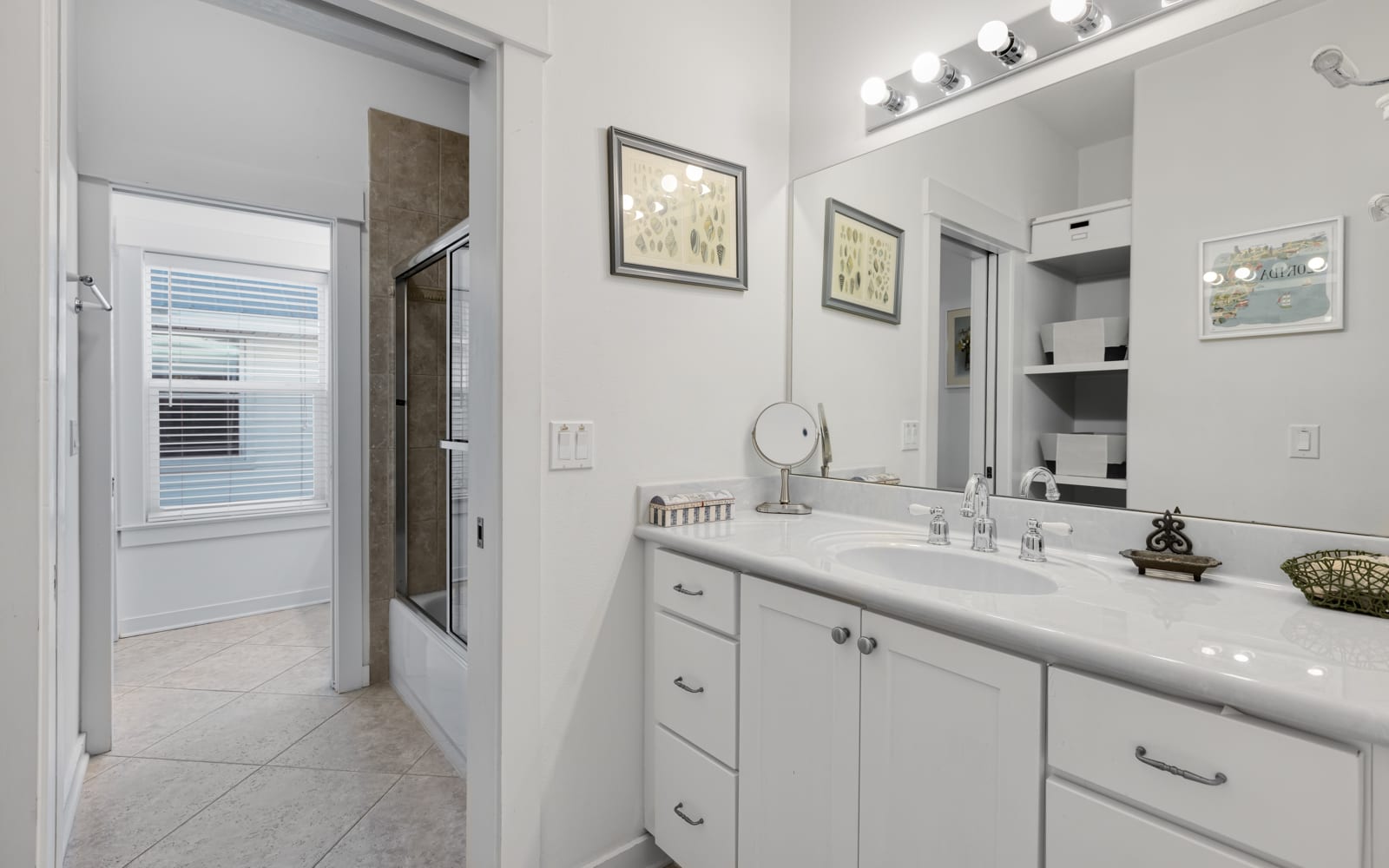 Step into your pristine bathroom with gleaming countertops, elegant vanity lighting, and a spacious shower waiting for your morning routine.