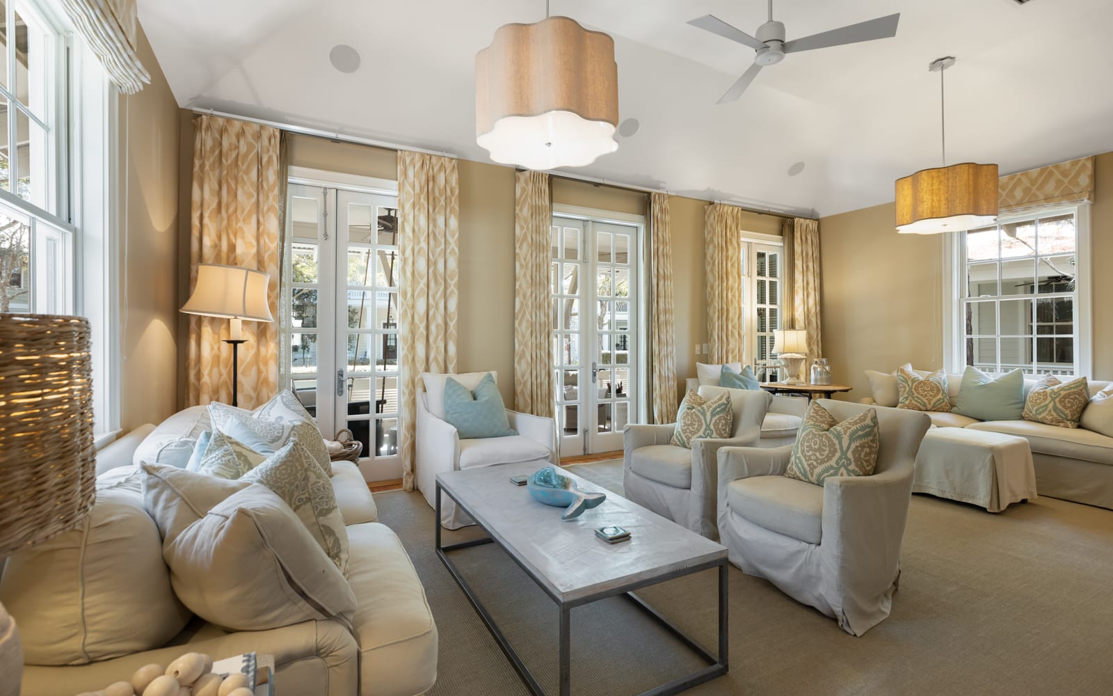 Sink into plush sofas and armchairs in your elegant living room, where soft lighting and French doors create a serene retreat.