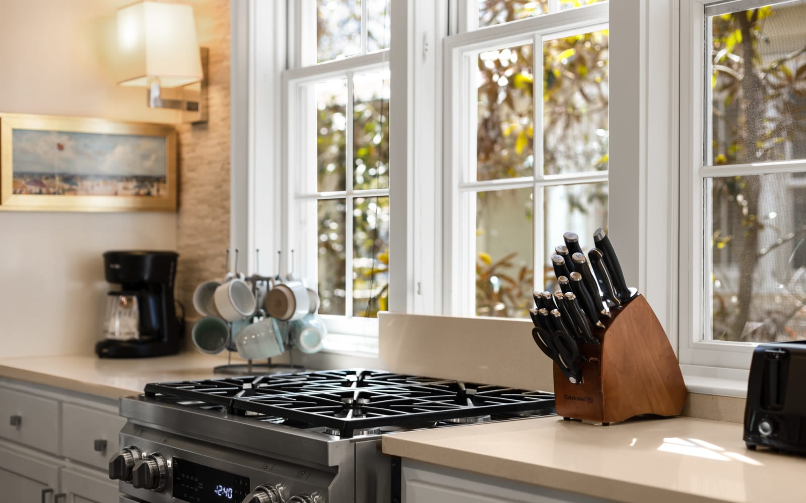 Your fully-equipped kitchen invites culinary adventures with professional-grade appliances, quality knife set, and sunlit workspace overlooking peaceful garden views.