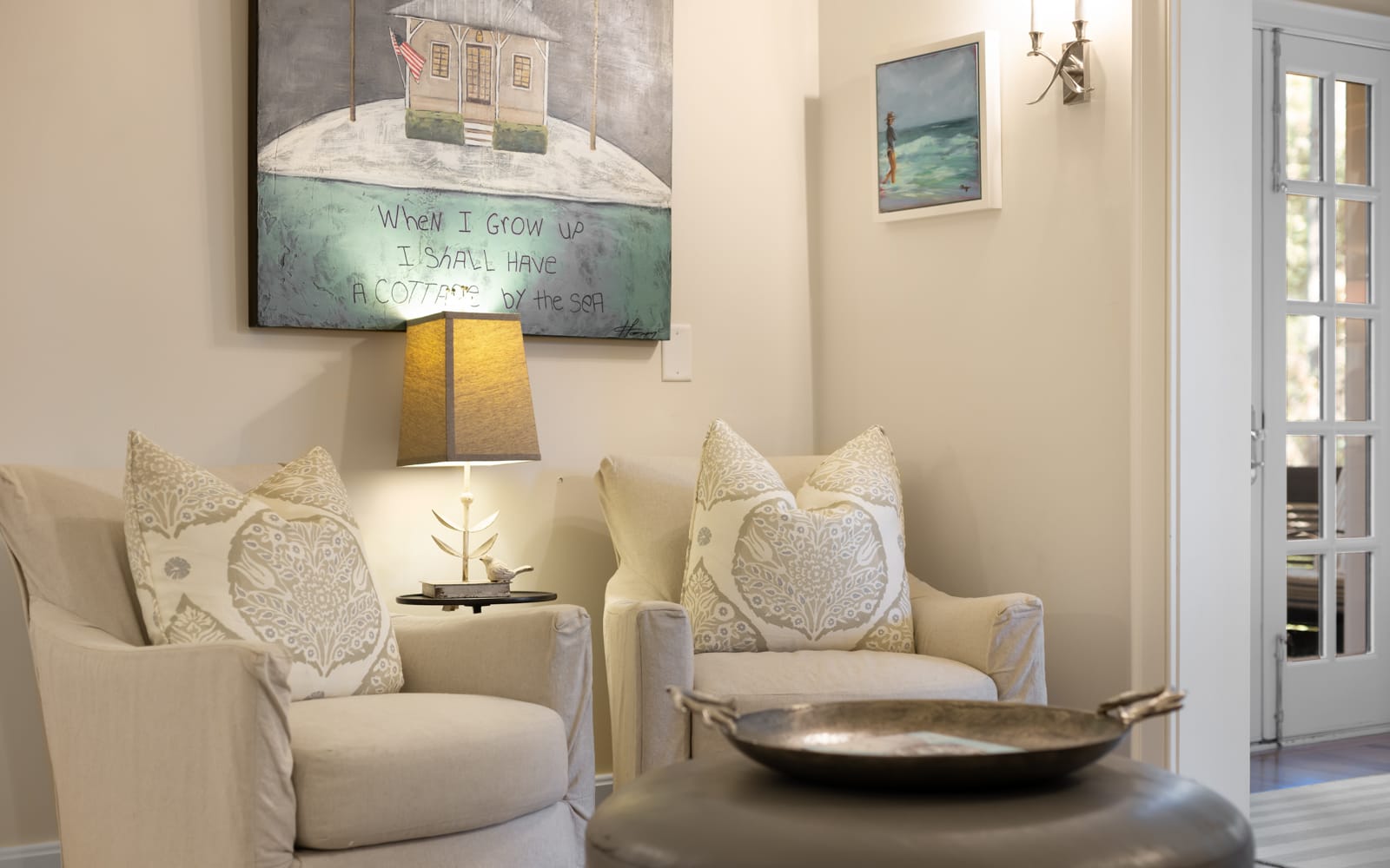 Sink into these plush armchairs and let the coastal artwork transport you to seaside serenity in your thoughtfully decorated retreat.