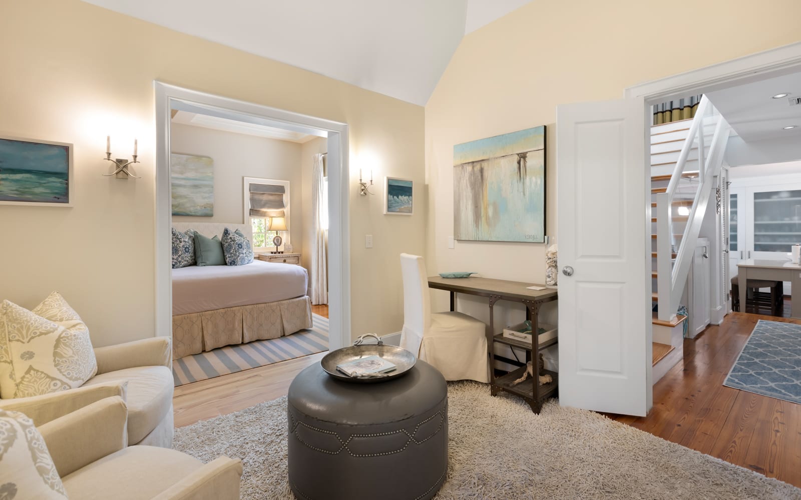 Relax in your elegant suite where coastal charm meets comfort—your private bedroom awaits beyond the inviting sitting area.