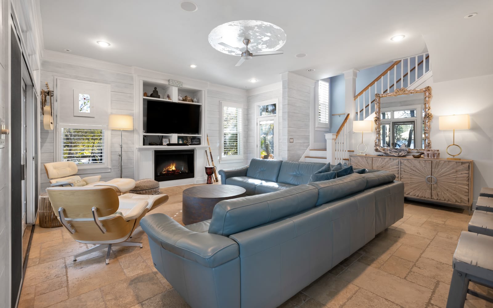 Unwind in this elegant living room where plush seating surrounds a cozy fireplace, perfect for relaxing evenings together.