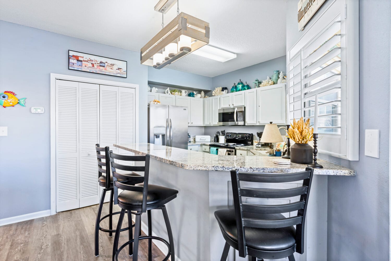Your fully equipped kitchen awaits with granite countertops and breakfast bar seating for casual coastal dining.