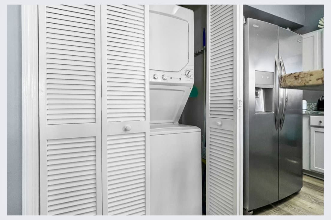 Your in-unit washer and dryer are tucked away behind stylish louvered doors, keeping your vacation wardrobe fresh and ready.