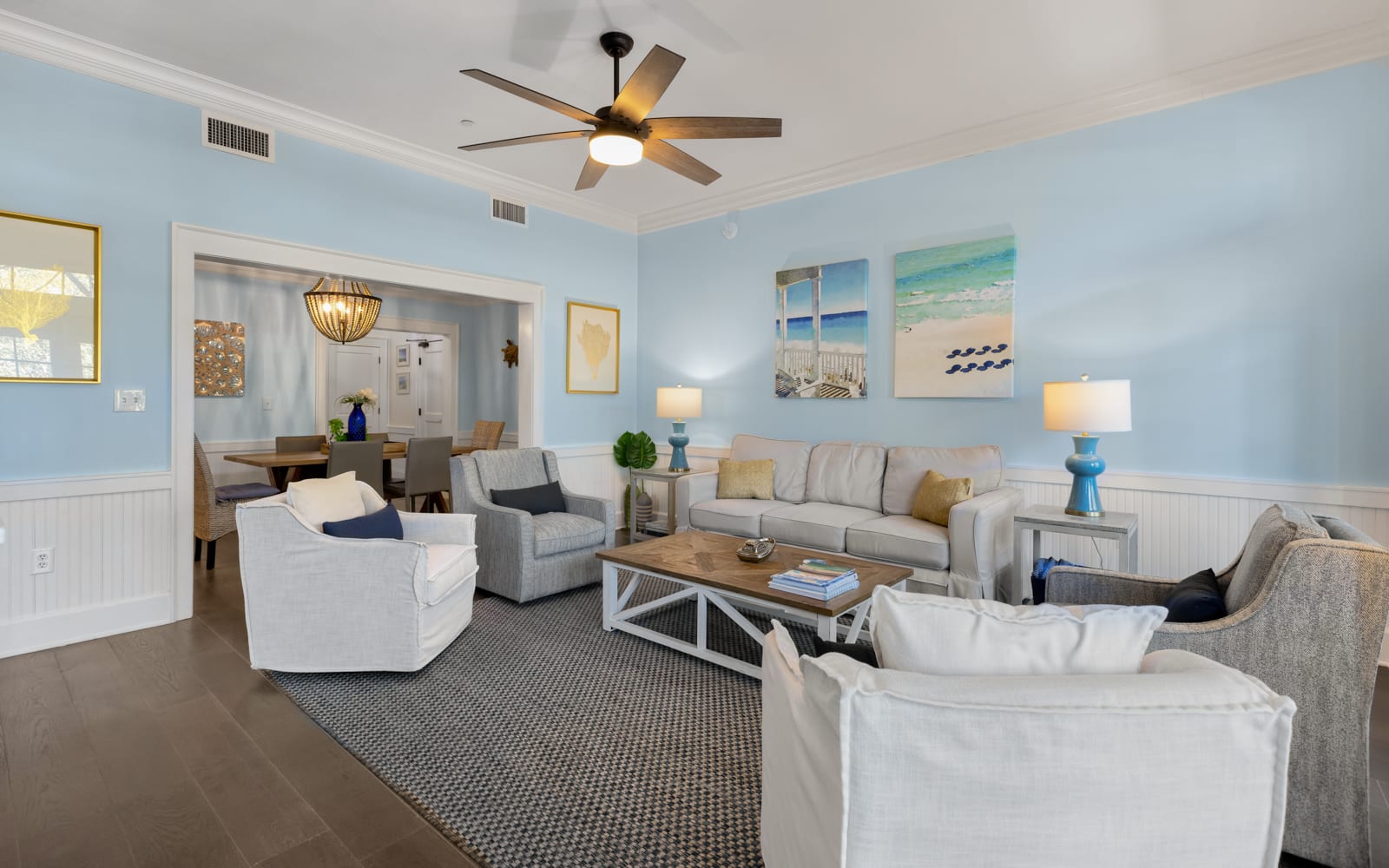 Unwind in your spacious coastal living room with plush seating and calming beach artwork that creates the perfect atmosphere for relaxation.