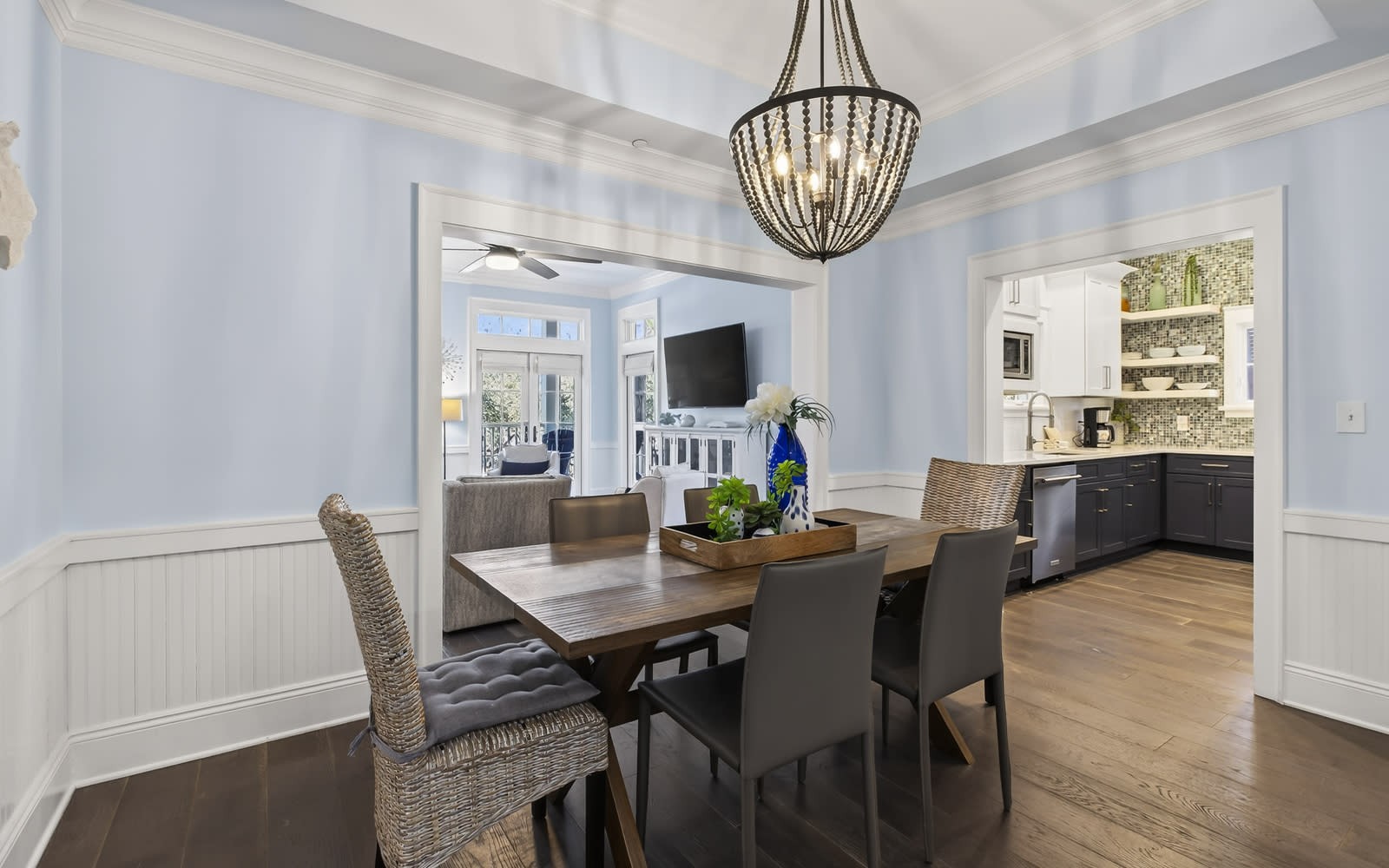 Gather around your elegant dining table beneath a stunning chandelier, with gleaming hardwood floors and an open kitchen perfect for entertaining.