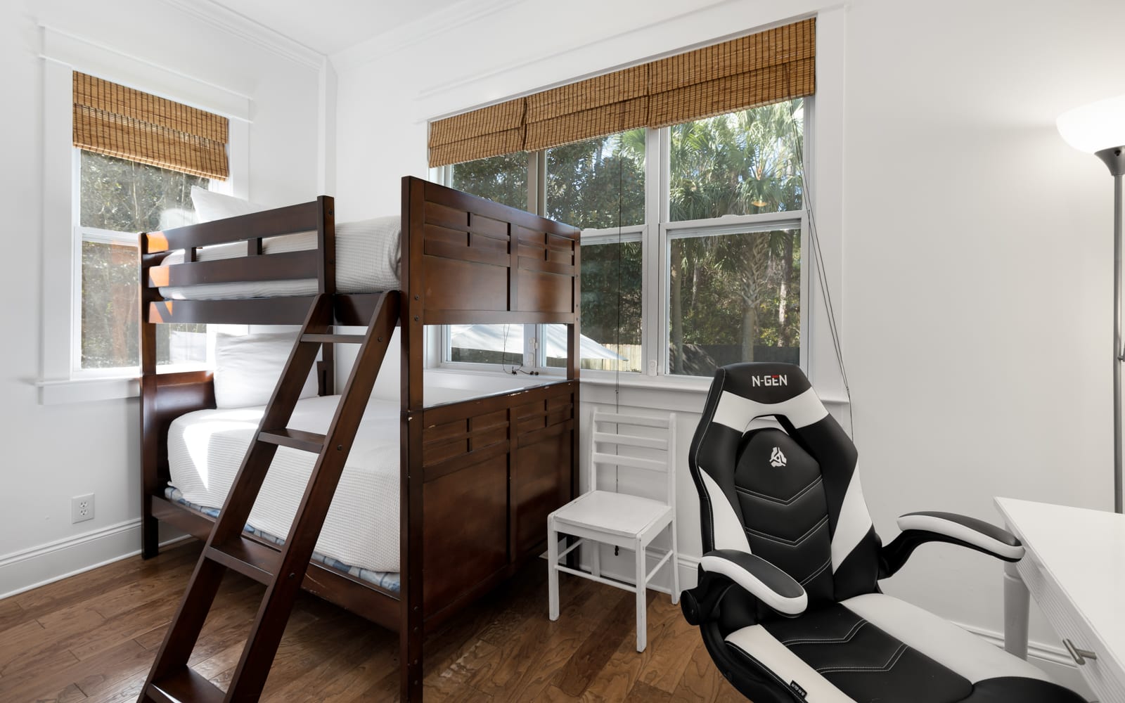 Your perfect space combines comfort and fun with cozy bunk beds and a gaming chair ready for your next adventure.