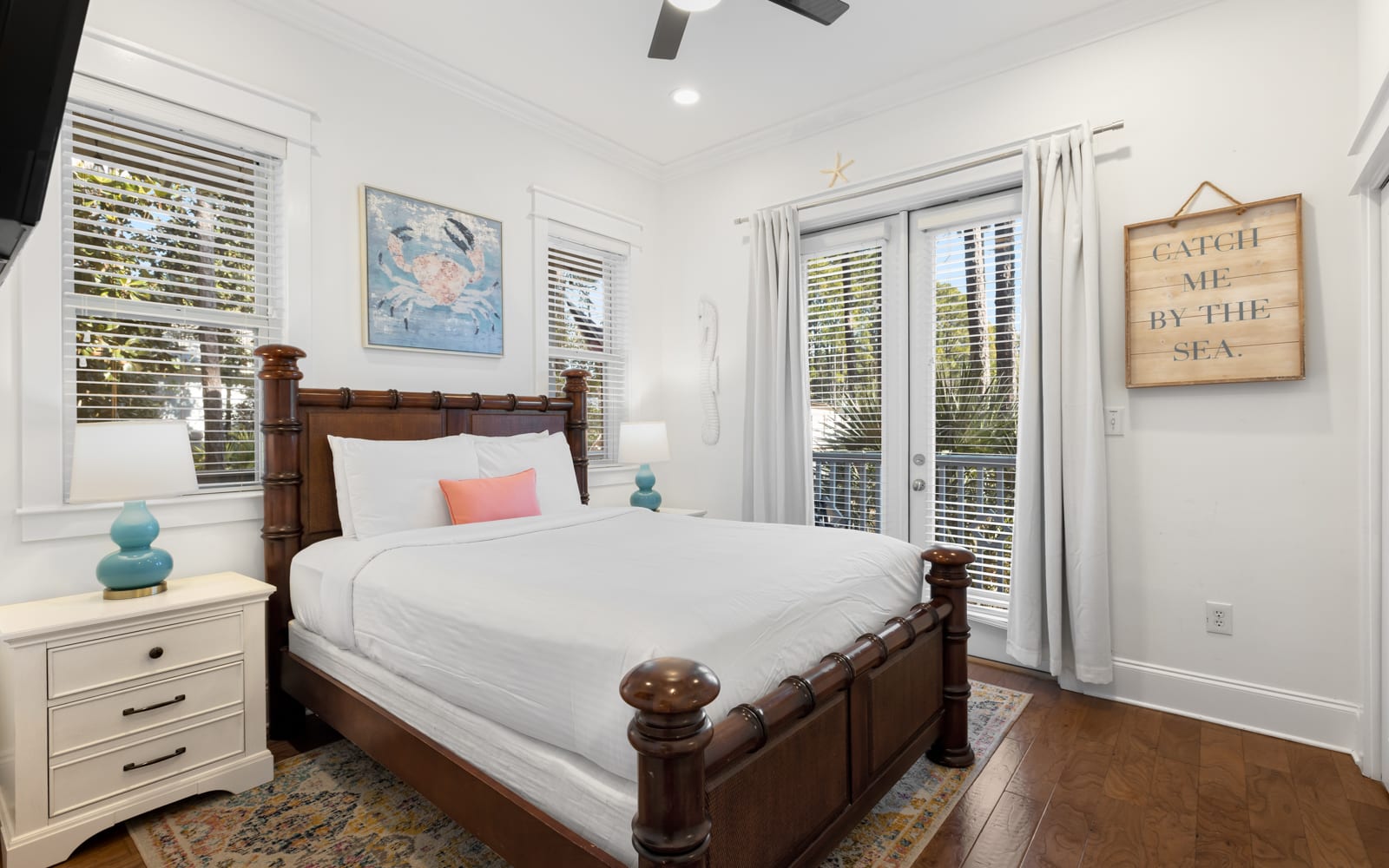 Your coastal bedroom retreat features a charming four-poster bed with crisp white linens and ocean-themed touches.