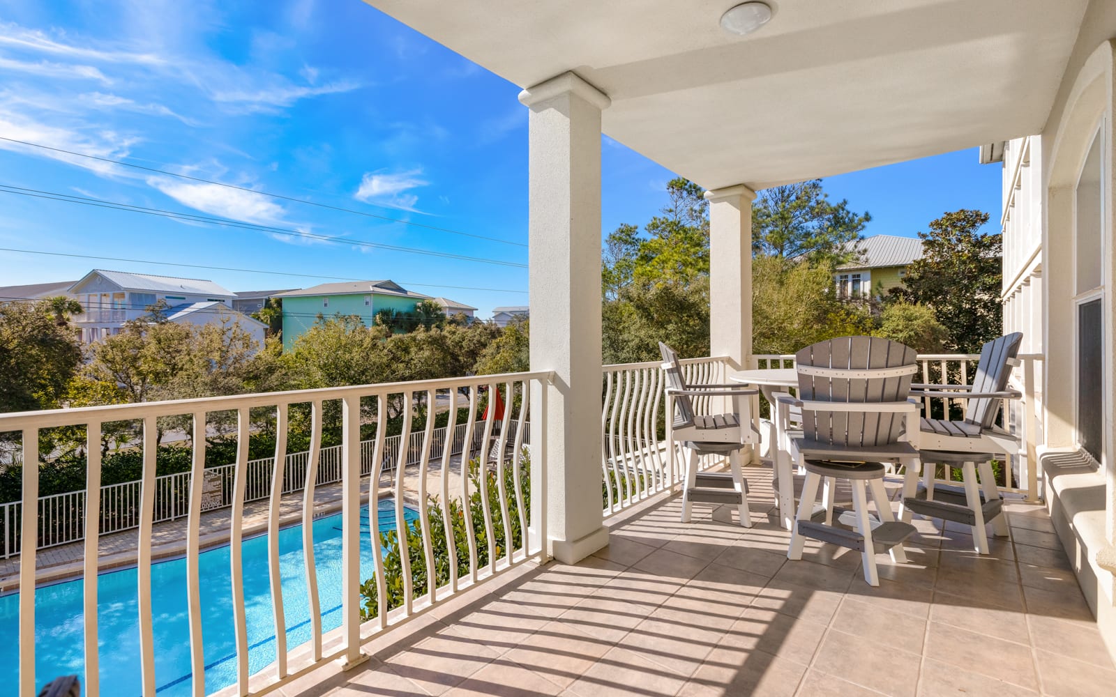 Relax on your private balcony overlooking the sparkling pool, where comfortable seating awaits your morning coffee or evening unwind.
