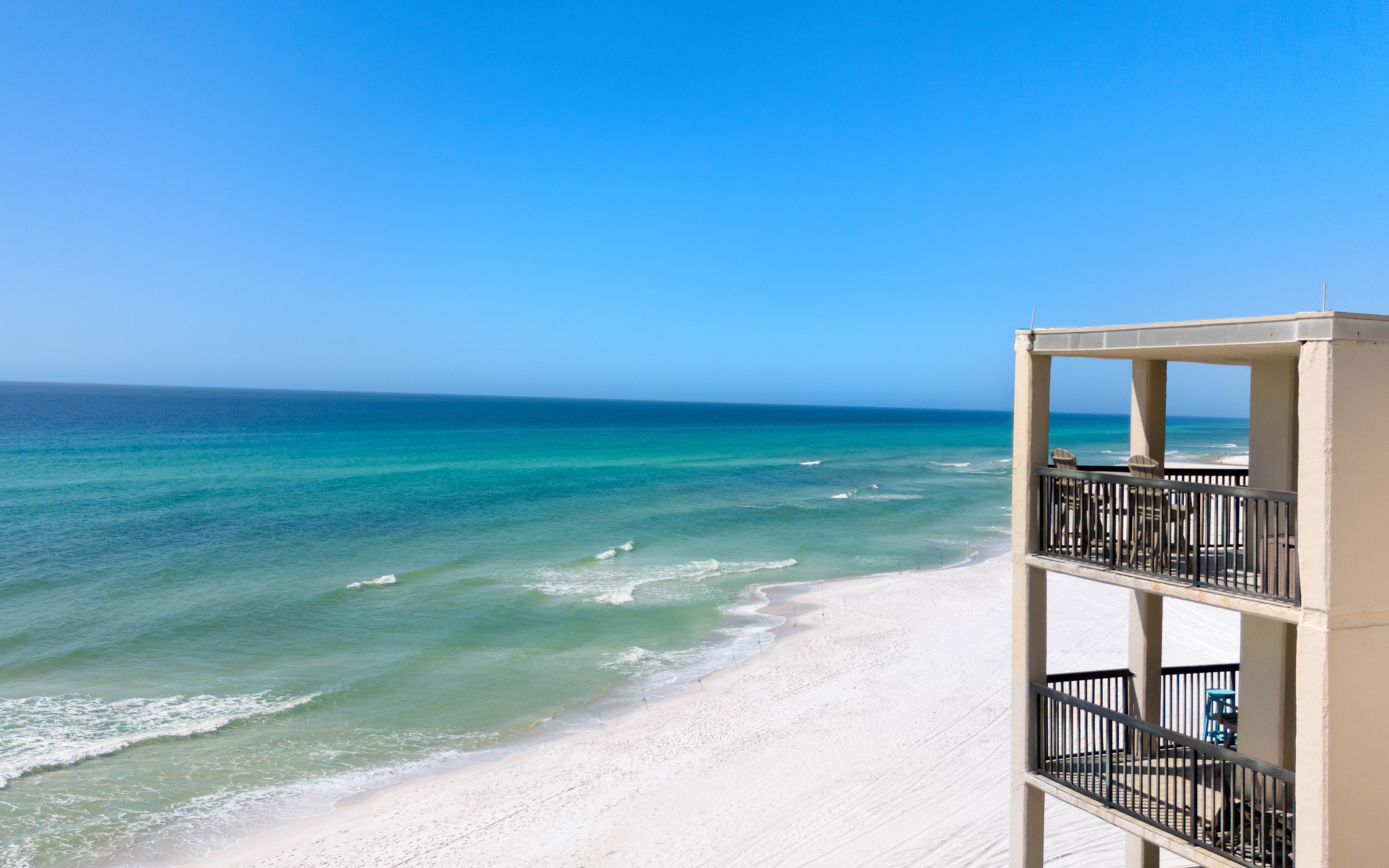 Gulf front property offers stunning Gulf Coast views with pristine white sand beaches and crystal-clear turquoise waters stretching to the horizon.