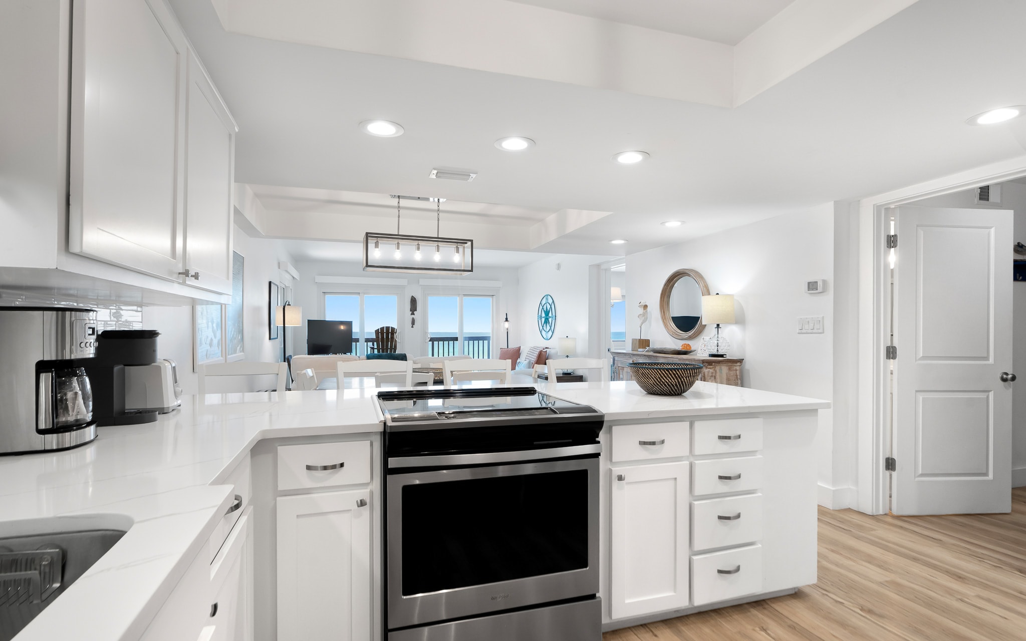 Your bright, modern kitchen invites culinary adventures with pristine white cabinets, sleek appliances, and an open flow to the living area.