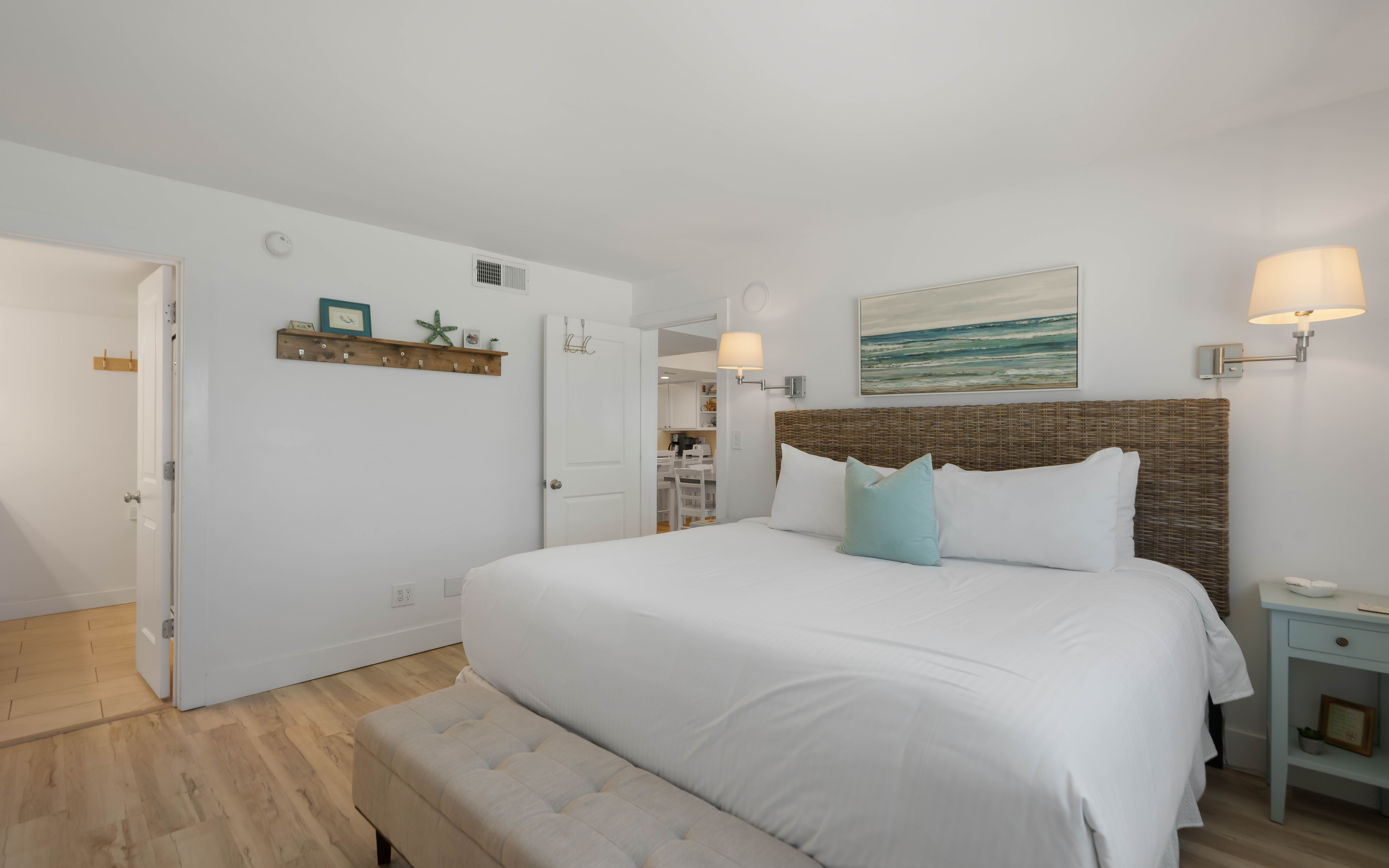 Drift off in your coastal-inspired bedroom with ocean artwork and soft linens creating the perfect beach getaway vibe.