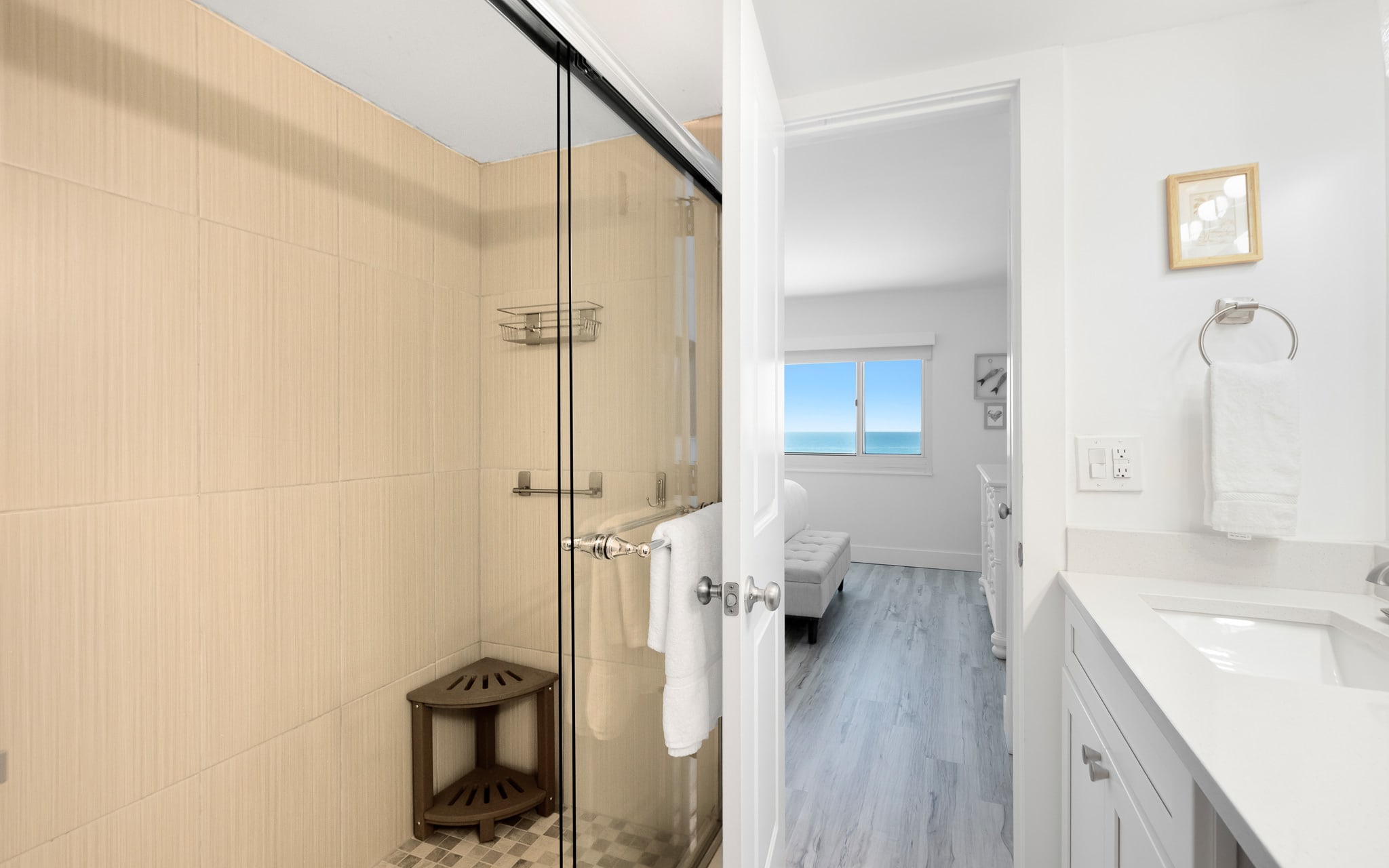 Your bright, modern bathroom features a spacious glass shower and opens to a bedroom with stunning gulf views.