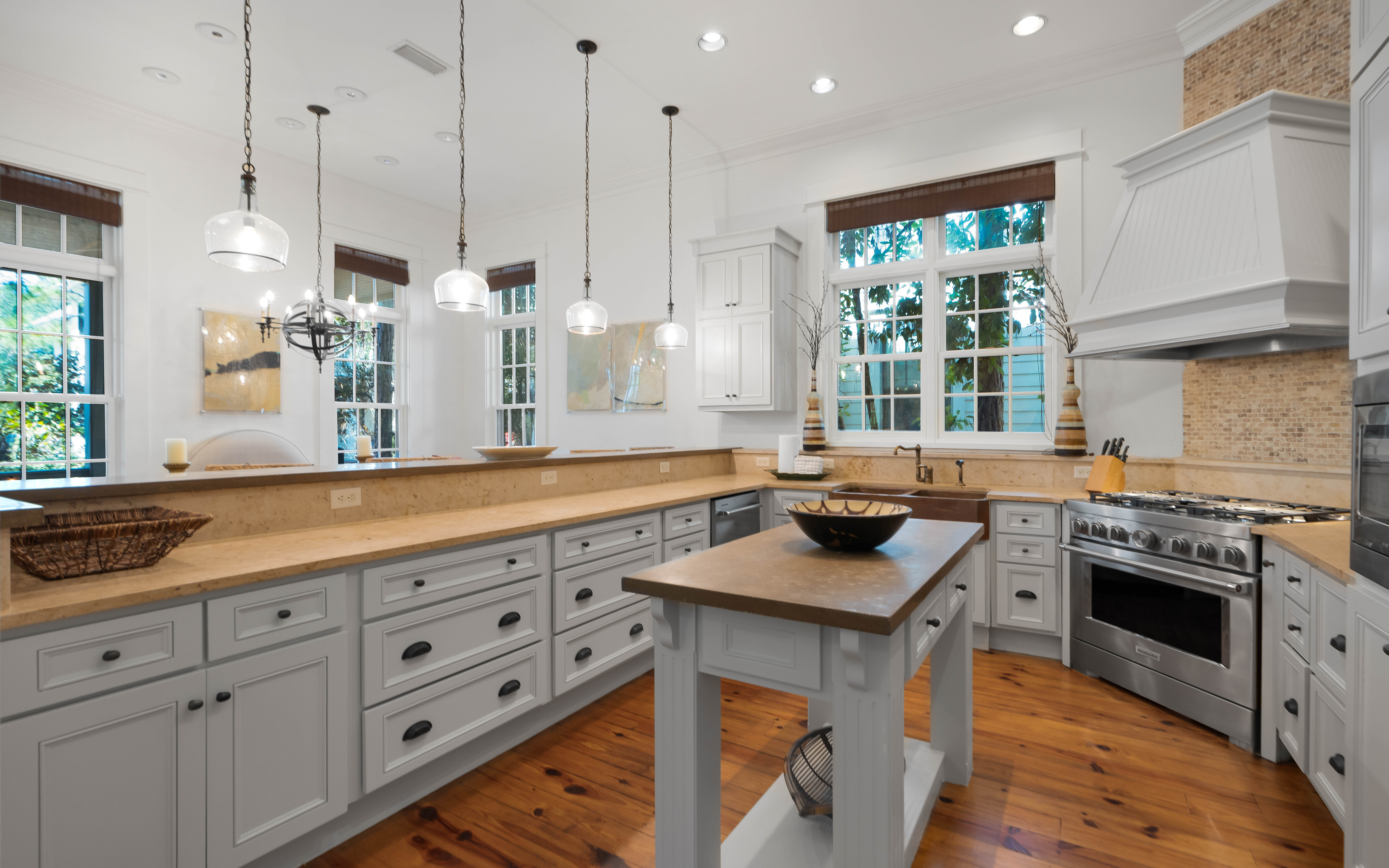 Your spacious kitchen invites culinary adventures with gleaming countertops, modern appliances, and warm natural light streaming through charming windows.