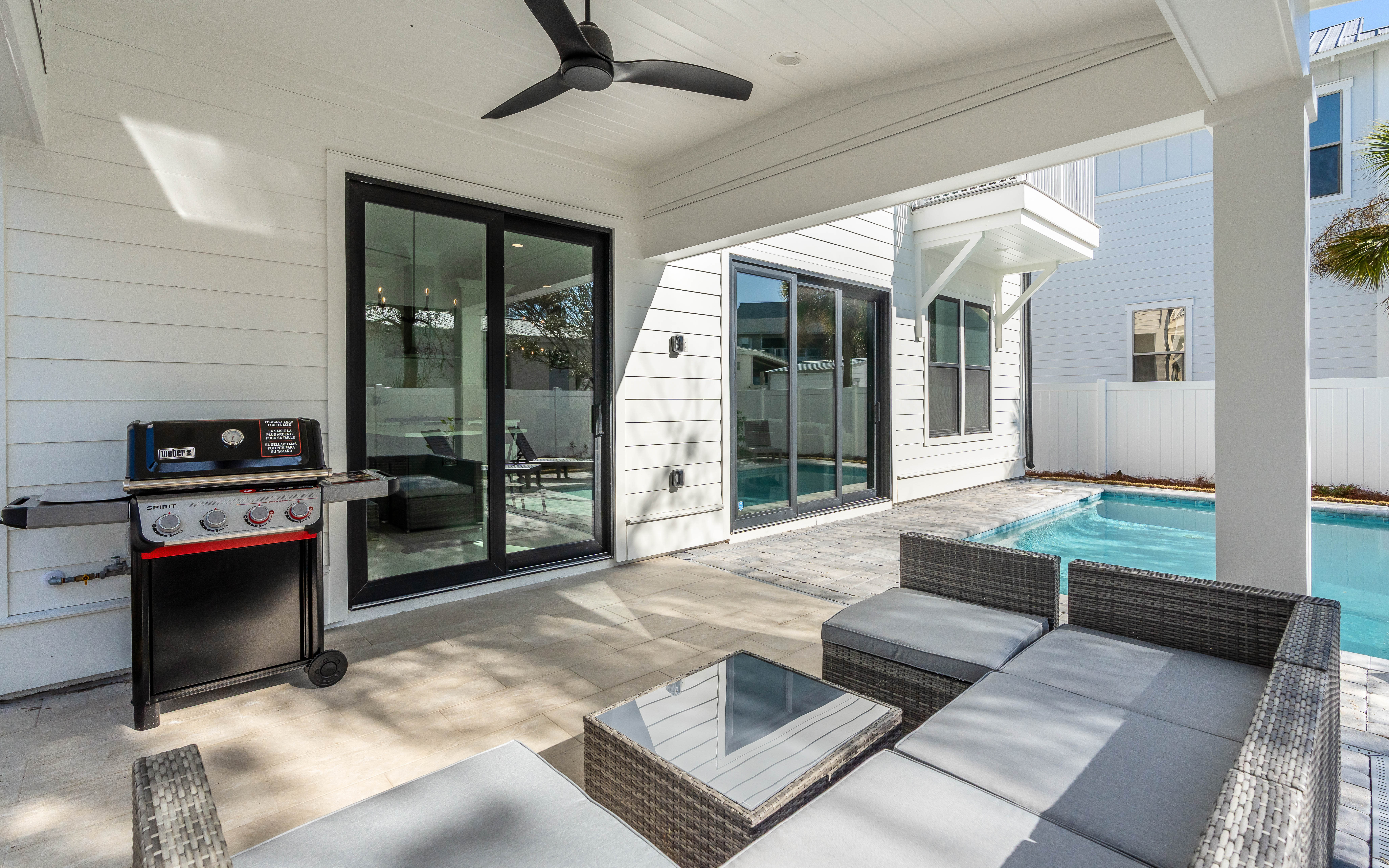 Relax poolside under your covered patio with BBQ, modern seating, and refreshing pool steps away for the perfect vacation retreat.