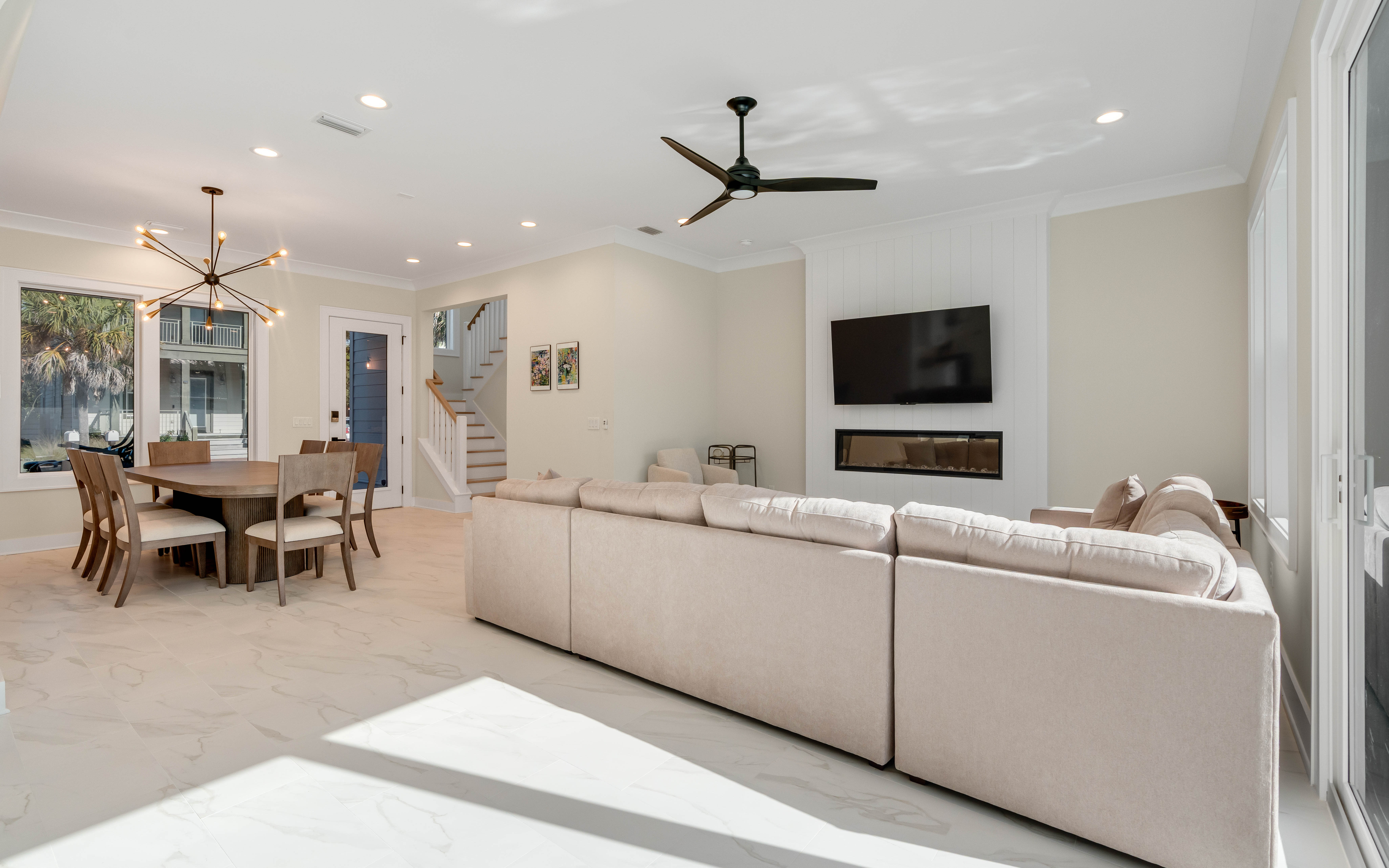 Sink into plush seating while enjoying your favorite shows on the wall-mounted TV, with elegant dining space perfect for memorable meals together.