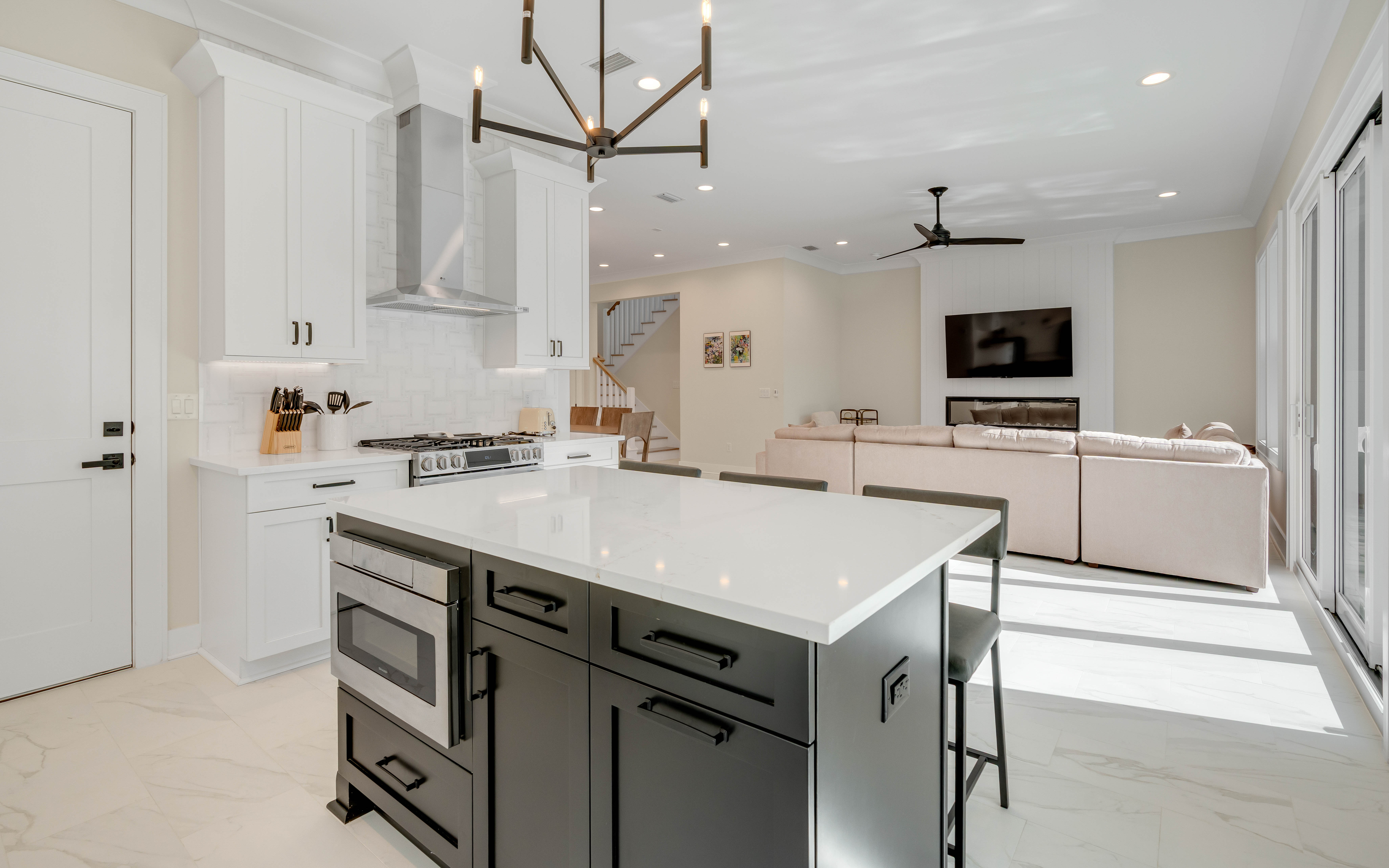 Your spacious kitchen flows seamlessly into the living area, featuring marble countertops, professional appliances, and an island perfect for morning coffee or evening conversations.