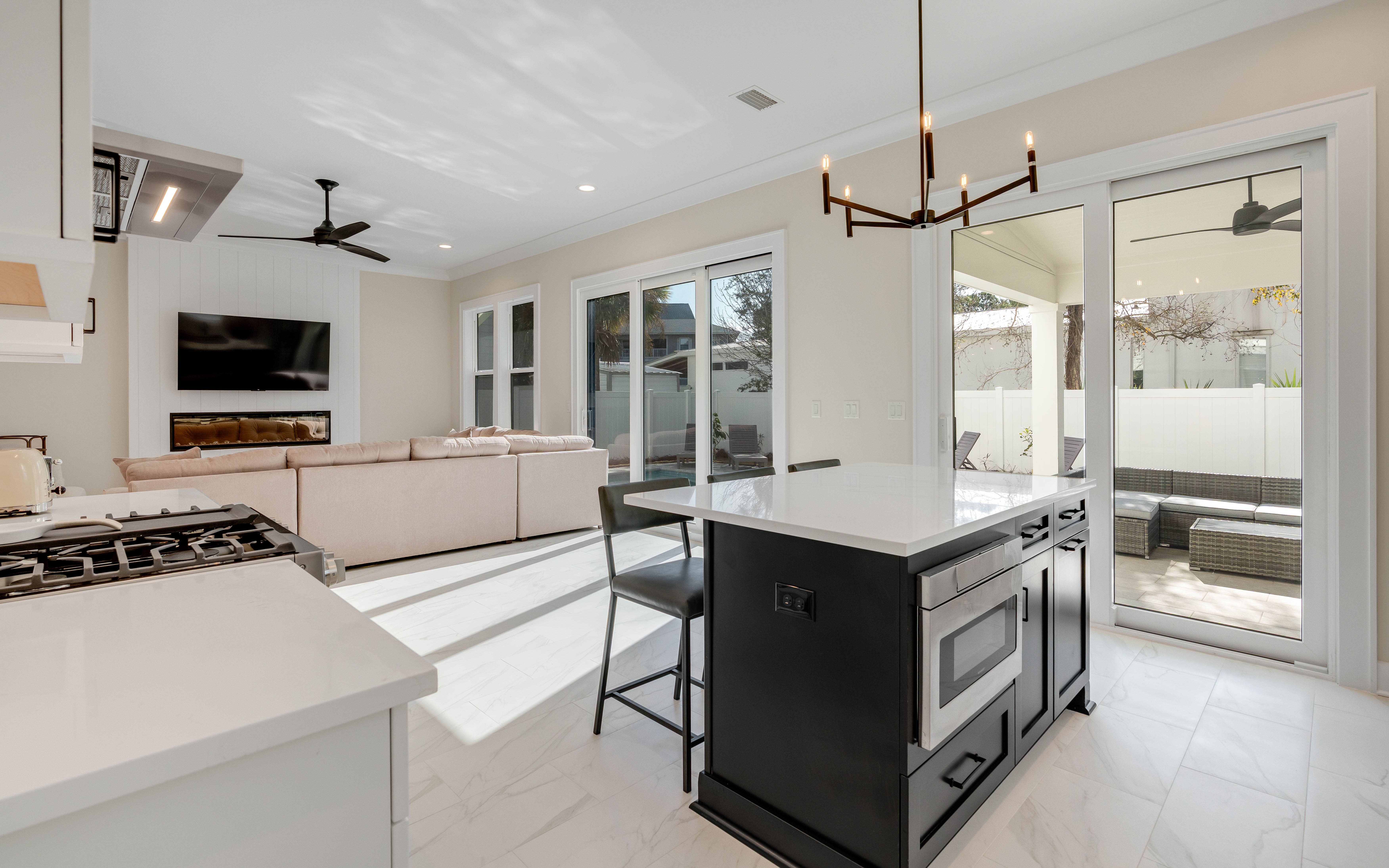 Your modern open-plan sanctuary seamlessly blends kitchen, dining, and living spaces, with sleek surfaces and large windows flooding the area with natural light.