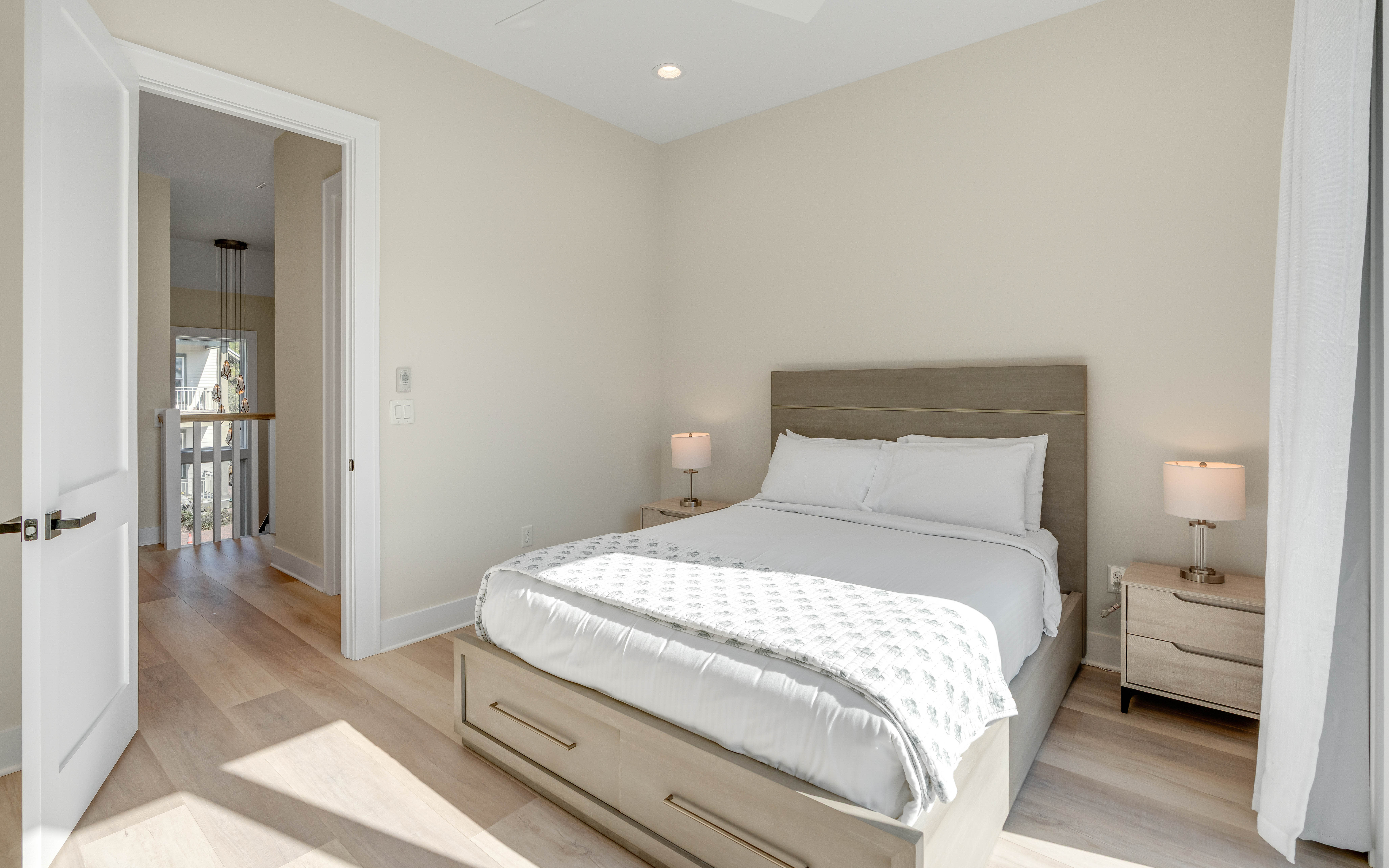 Your serene bedroom sanctuary awaits with crisp linens, warm bedside lighting, and contemporary comfort for the perfect night's rest.