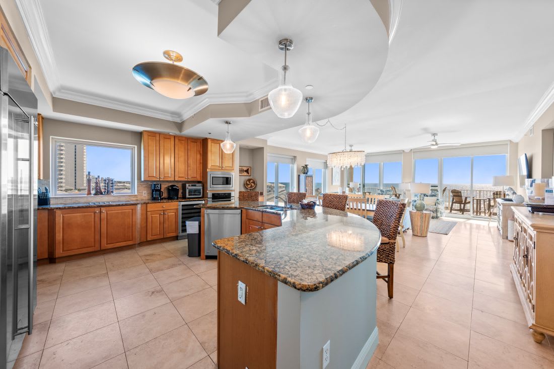 Your gourmet kitchen opens to stunning city views through floor-to-ceiling windows, creating the perfect space for cooking and entertaining.