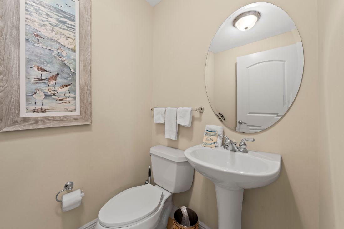 Your private powder room features coastal-themed art and fresh linens, creating a welcoming space for freshening up during your stay.