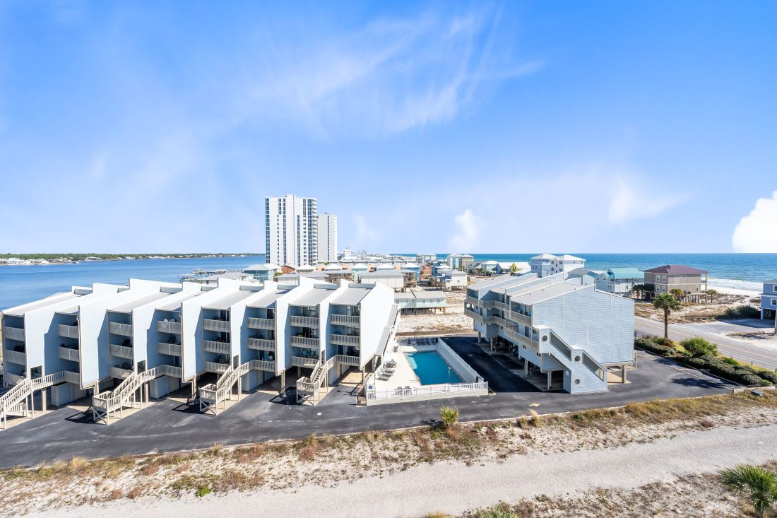 Coastal resort complex with beach access, swimming pool, and modern accommodations near the Gulf waters.