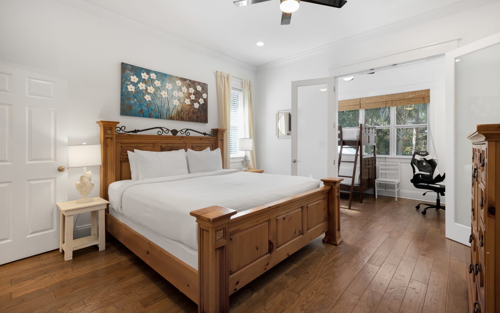 Relax in your peaceful bedroom with rich hardwood floors, custom wooden furnishings, and crisp linens for perfect rest.