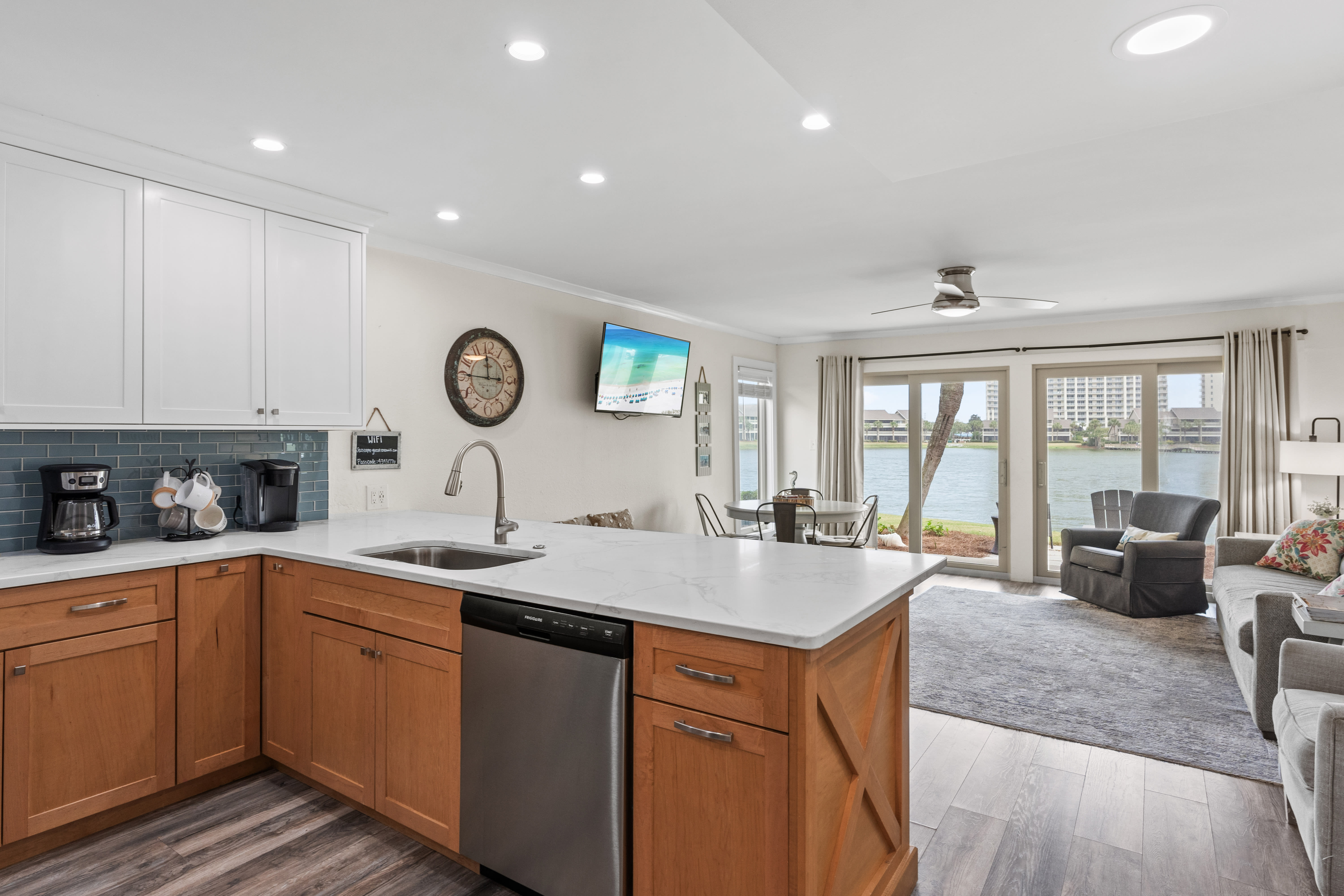 Your spacious waterfront retreat features a sleek modern kitchen flowing into a comfortable living area with stunning lake views right outside your door.