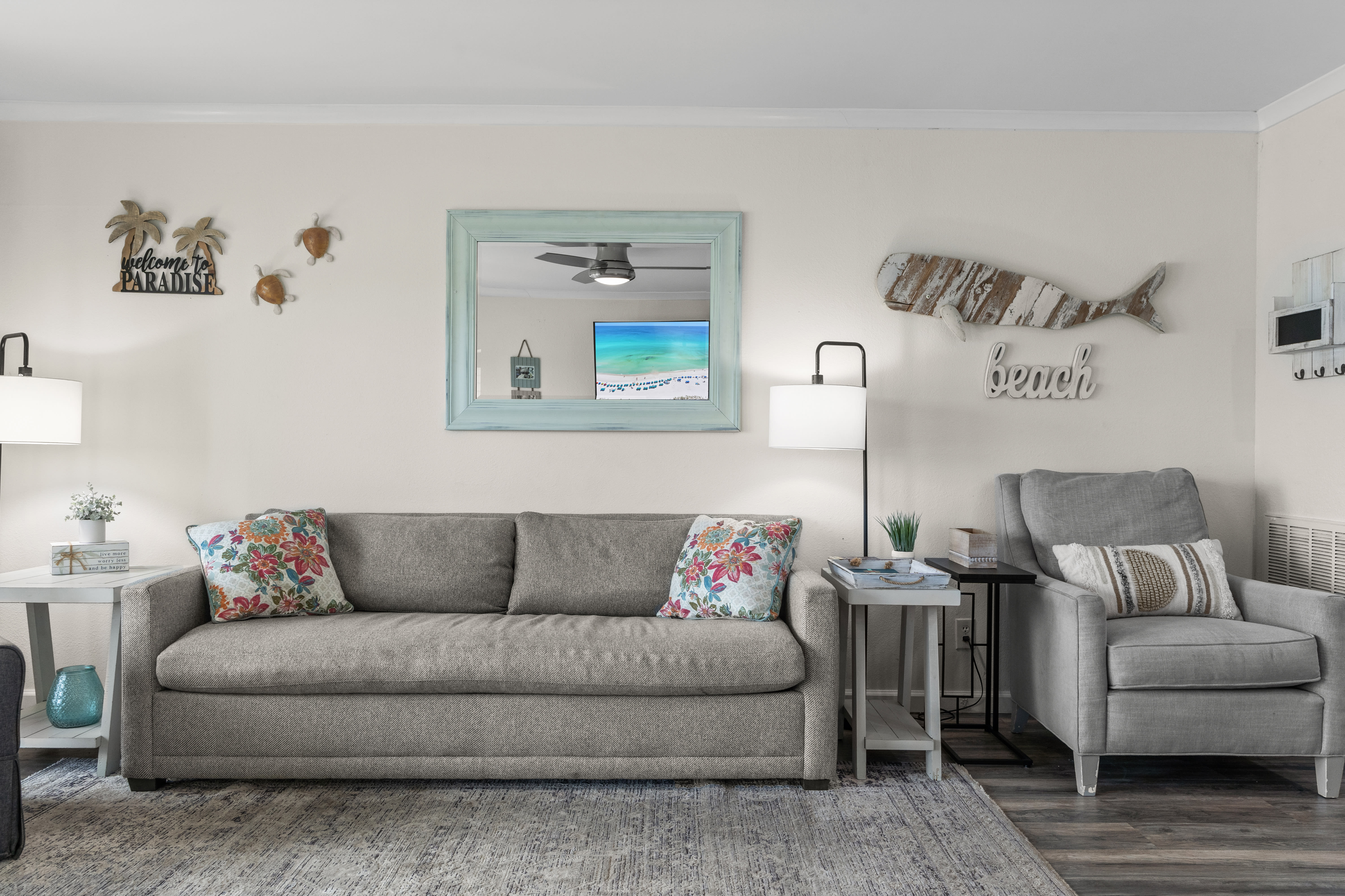 Sink into plush seating with tropical touches and beach-themed decor creating your perfect coastal retreat atmosphere.