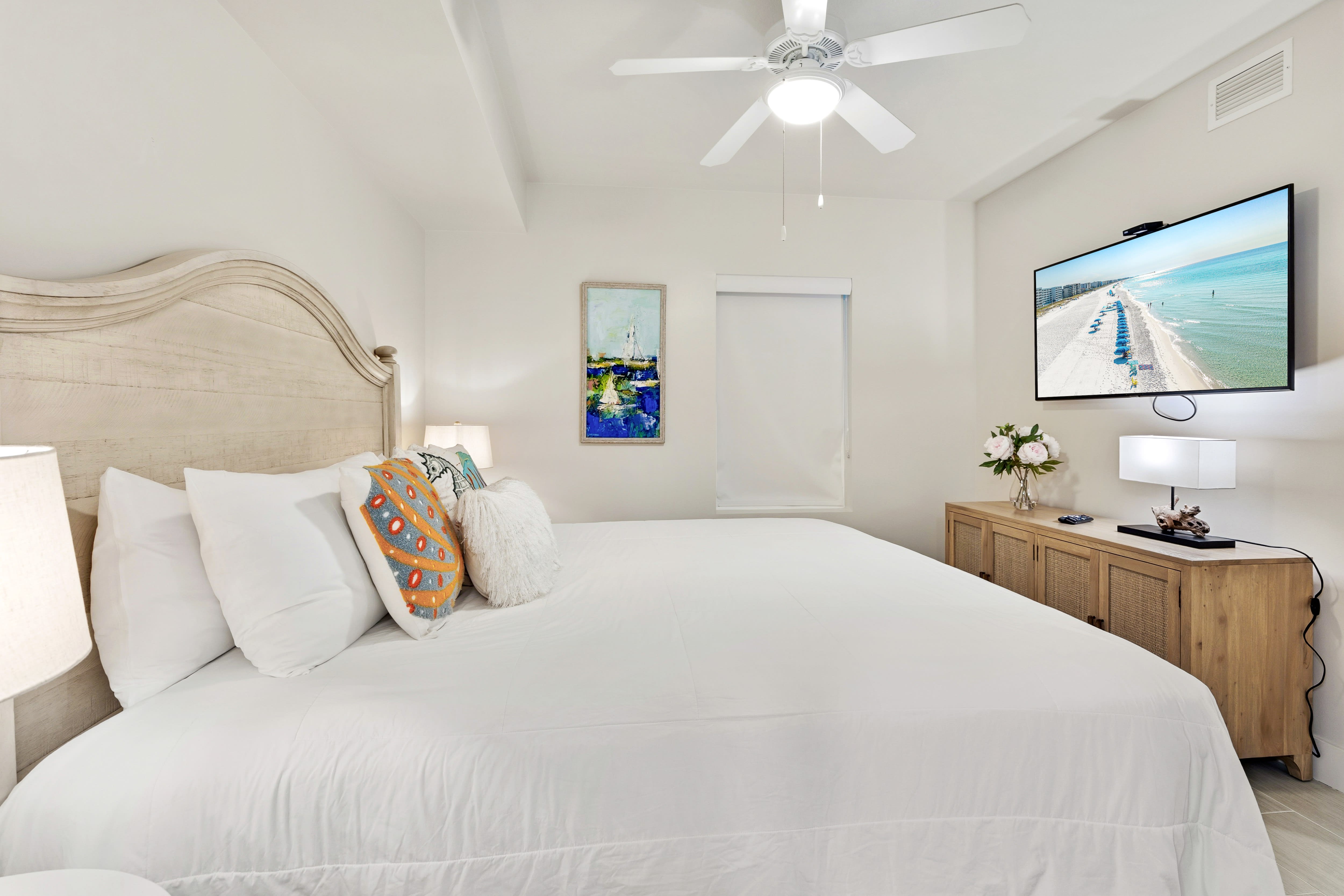 Drift off in your coastal bedroom, where crisp white linens and ocean artwork create a serene sanctuary for restful nights.