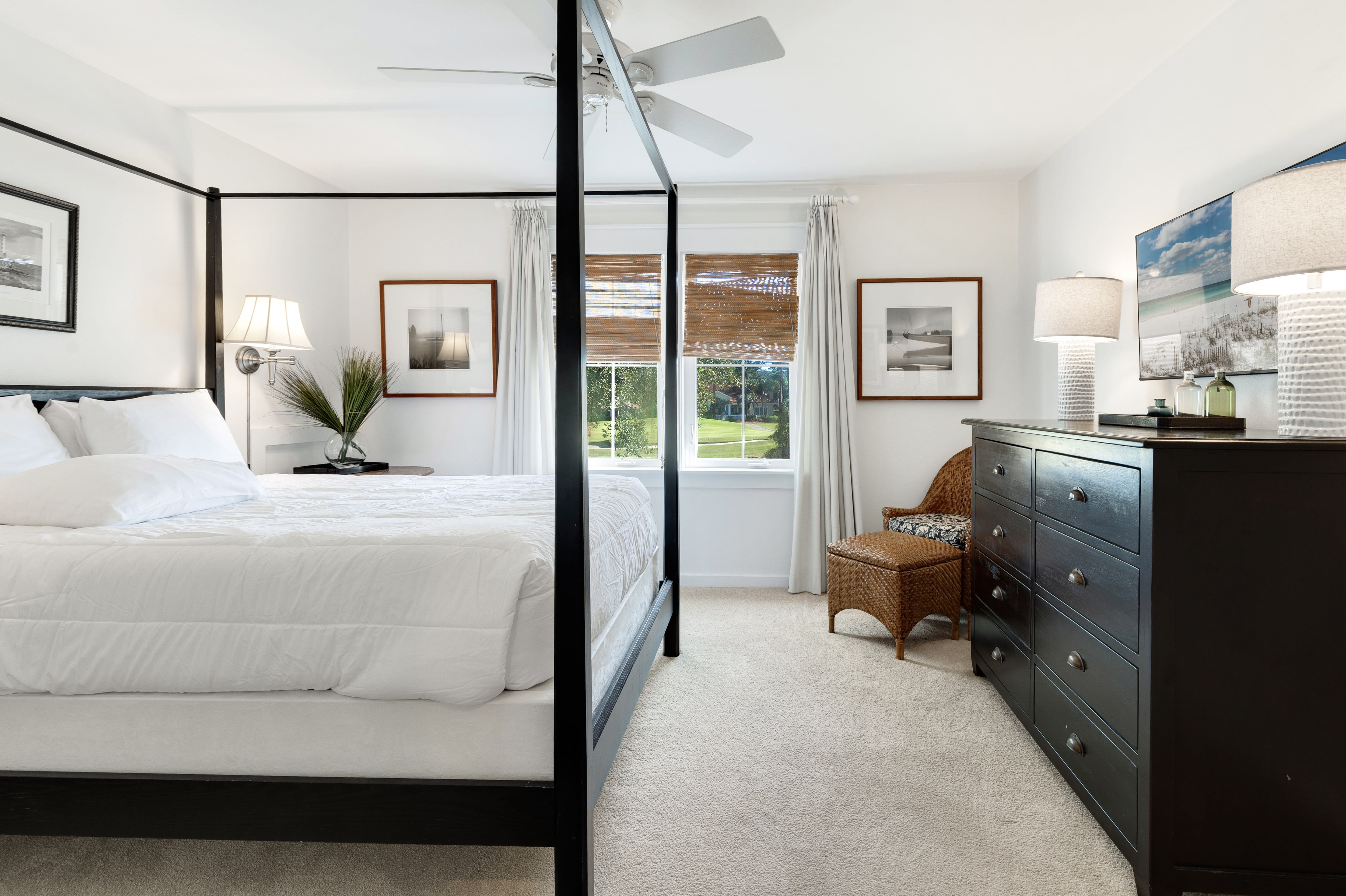 Unwind in your elegant master bedroom with a luxurious four-poster bed, crisp linens, and peaceful garden views through bamboo blinds.