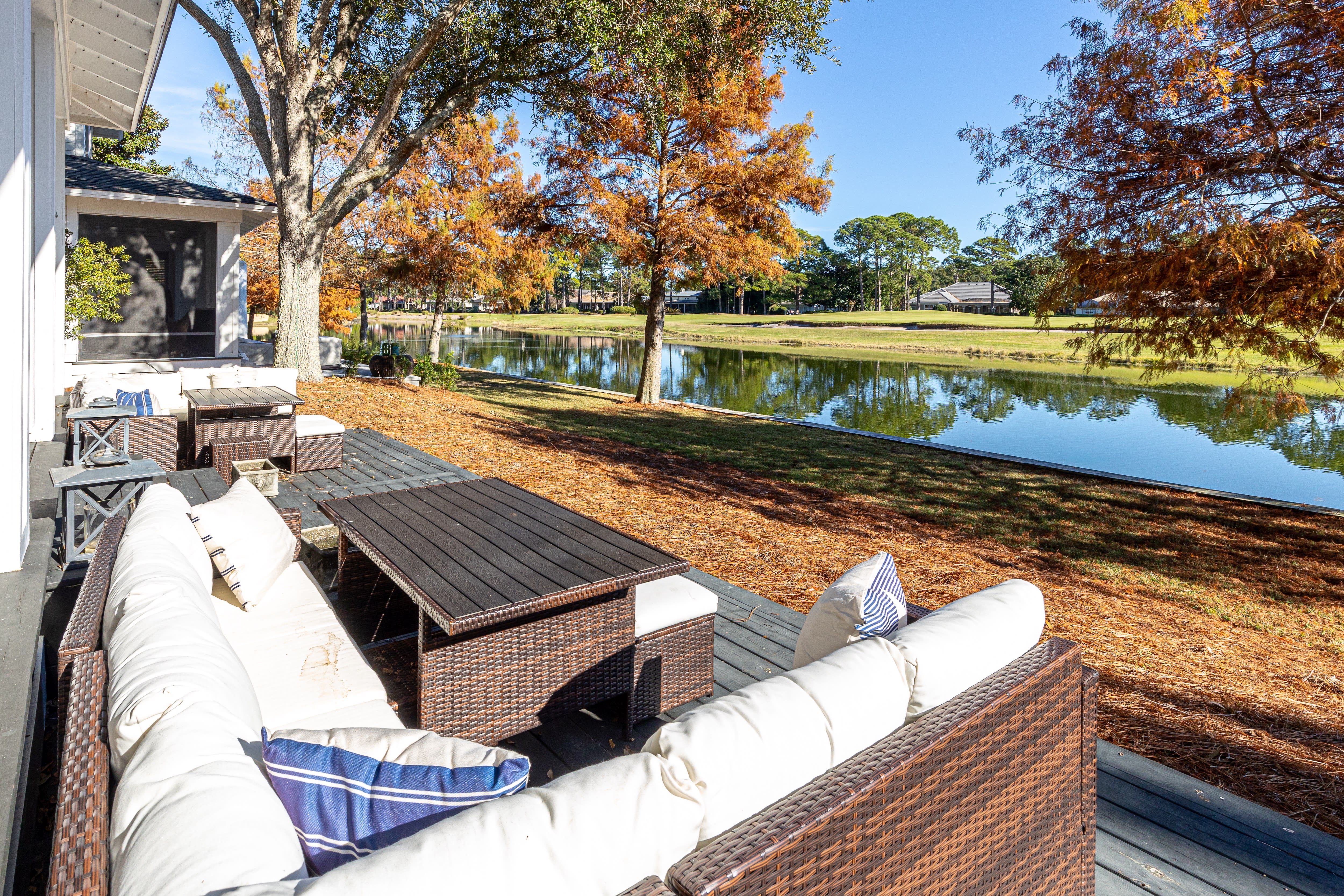 Scenic waterfront deck with autumn foliage and peaceful lake views creating a tranquil retreat.