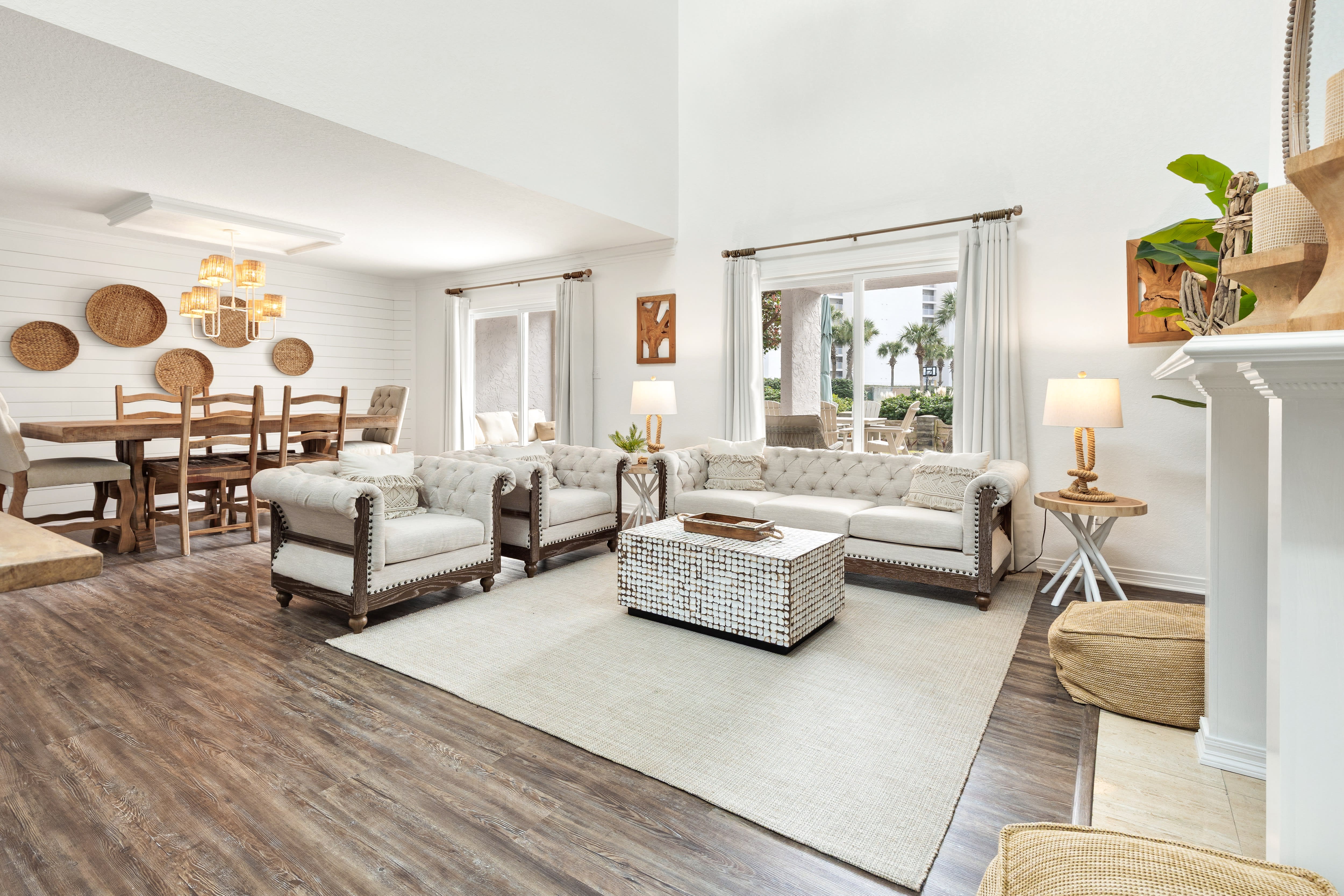 Relax in your bright, open living space featuring cozy tufted seating and natural textures that create the perfect atmosphere for unwinding.