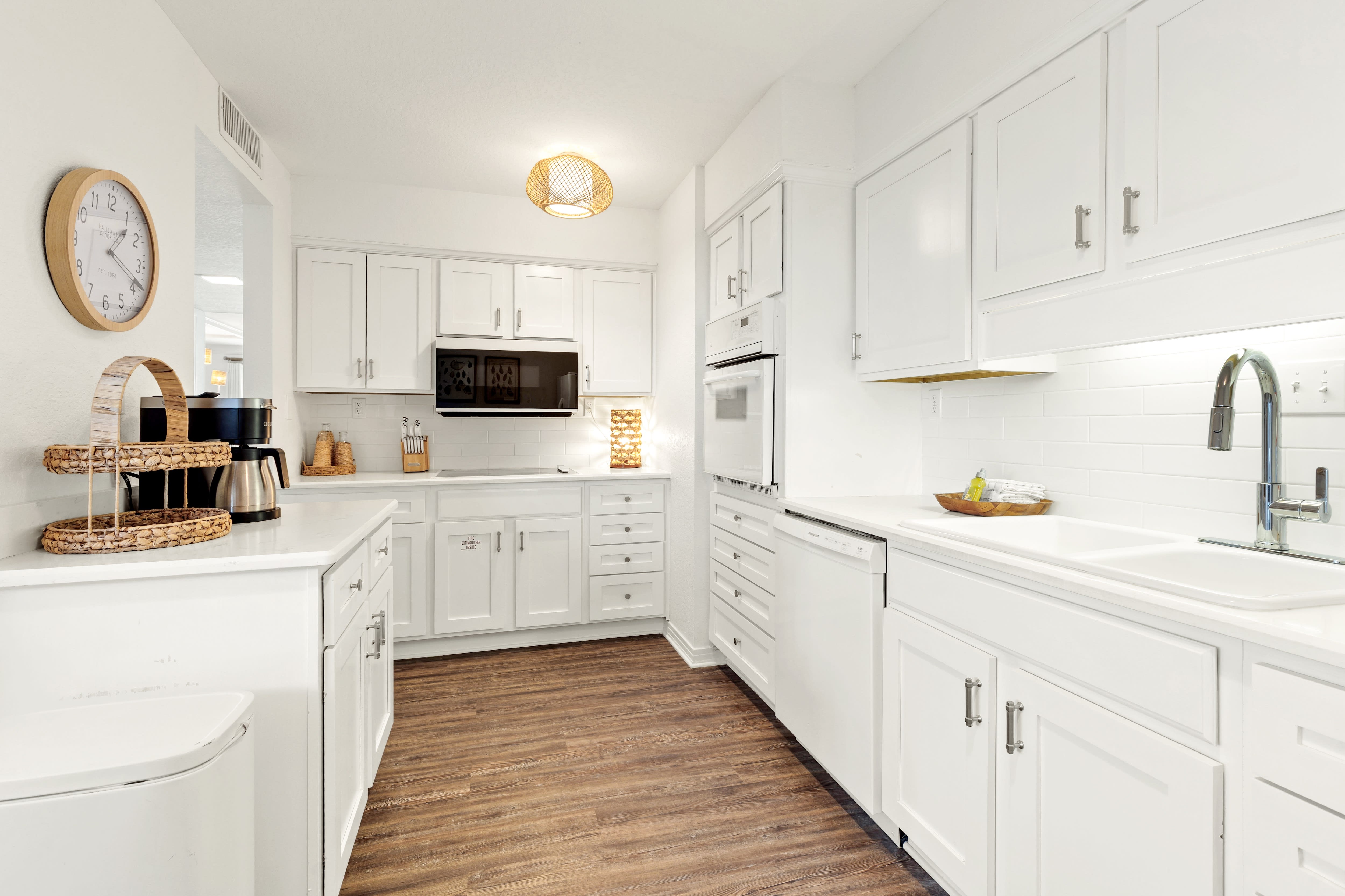 Your bright, fully-equipped kitchen awaits with crisp white cabinets, modern appliances, and ample counter space for preparing memorable meals.