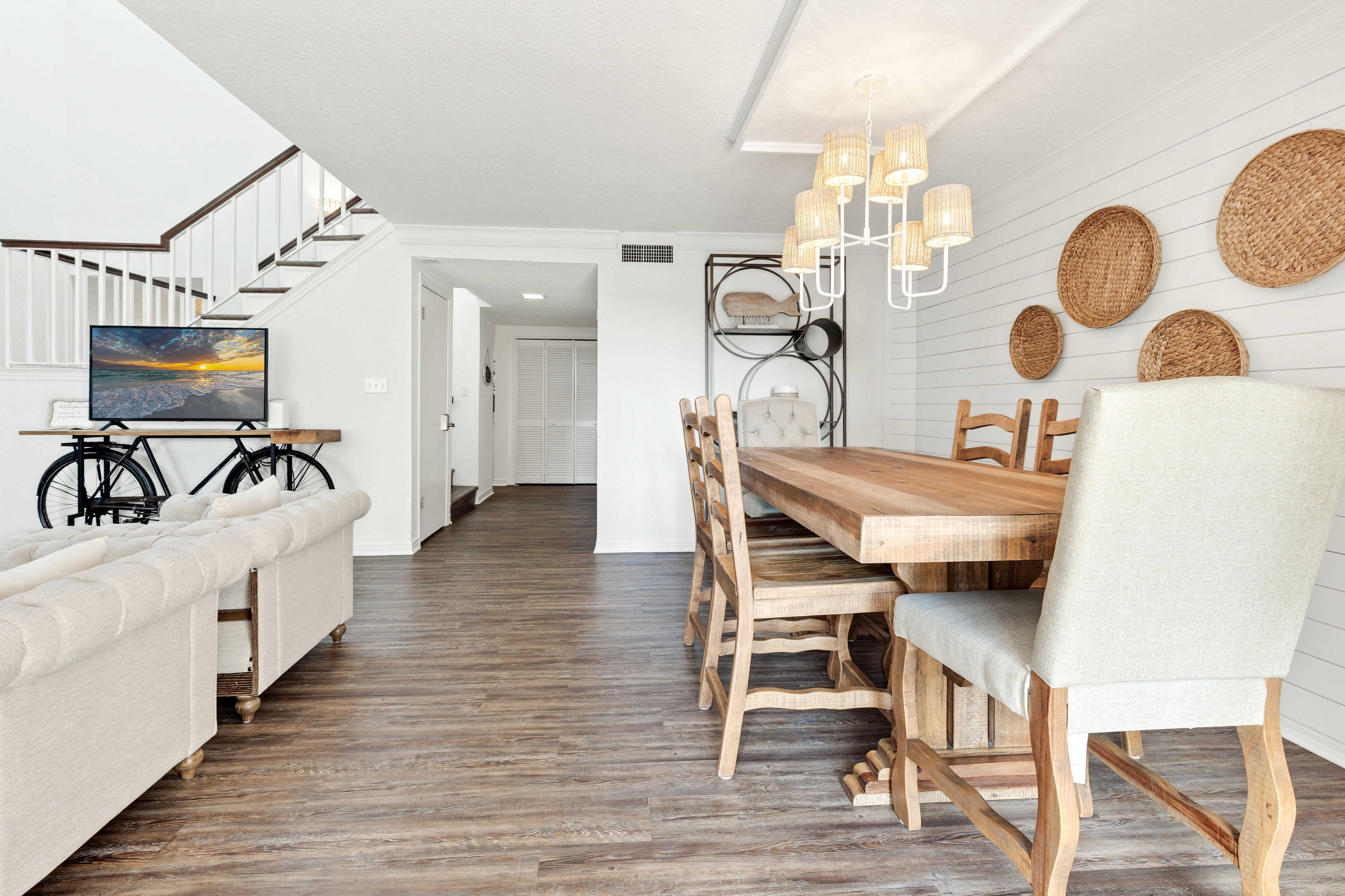 Unwind in your stylish open-concept living space with warm wood floors, coastal decor, and everything you need for memorable meals together.