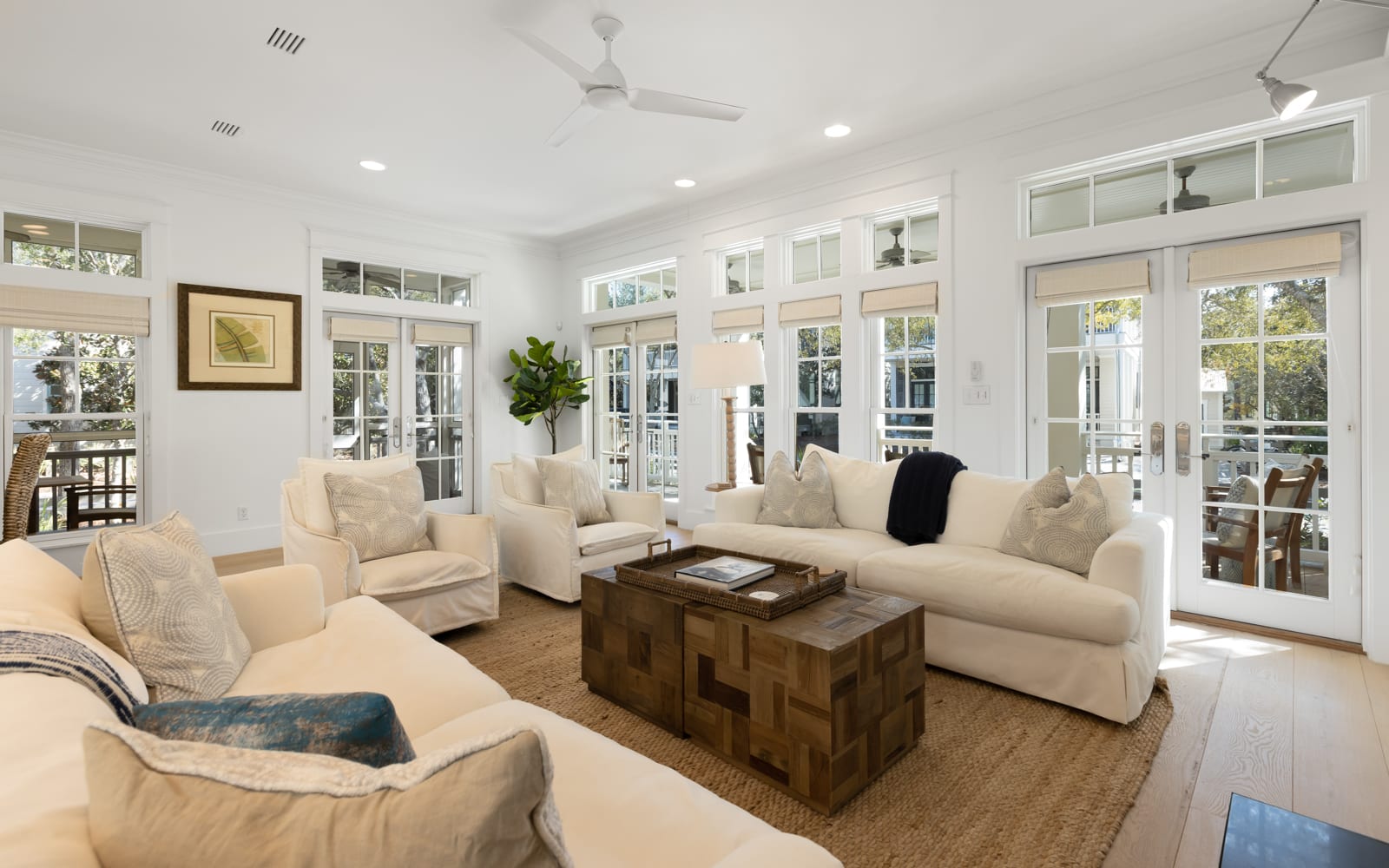 Relax in your bright living space with plush seating and French doors opening to outdoor views.
