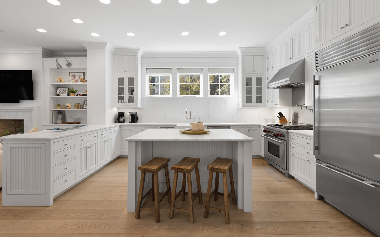 Your bright, fully equipped kitchen invites culinary adventures with stainless steel appliances, spacious island, and warm wood accents creating the perfect gathering spot.