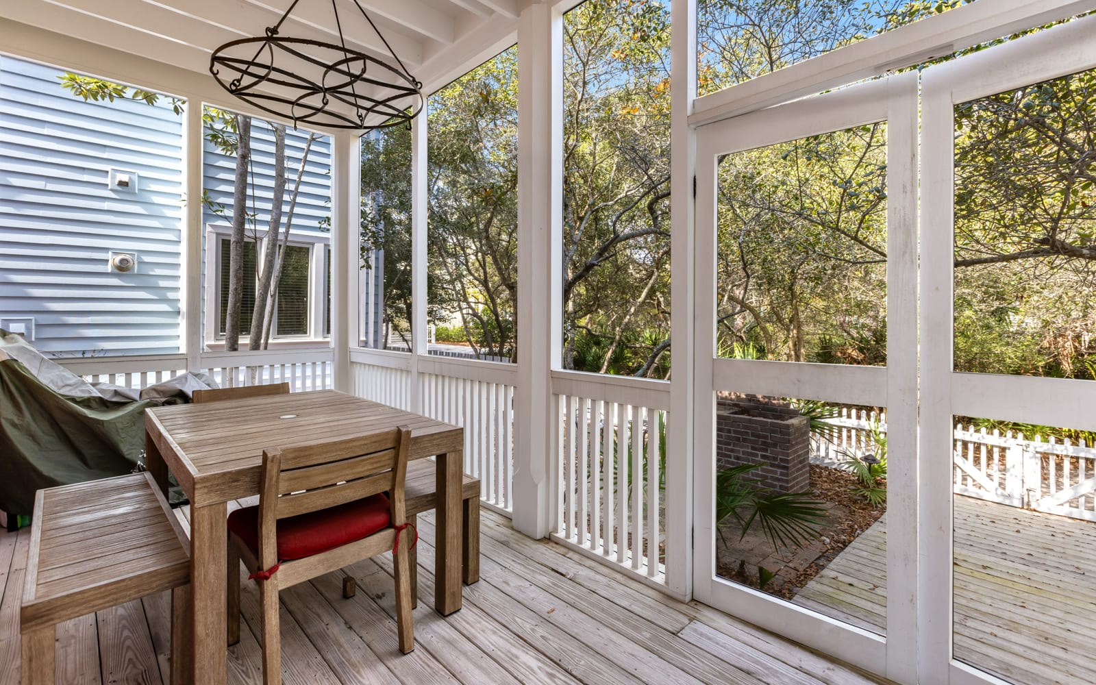 Unwind on your private screened porch, where natural light streams through panoramic windows framing lush treetop views.